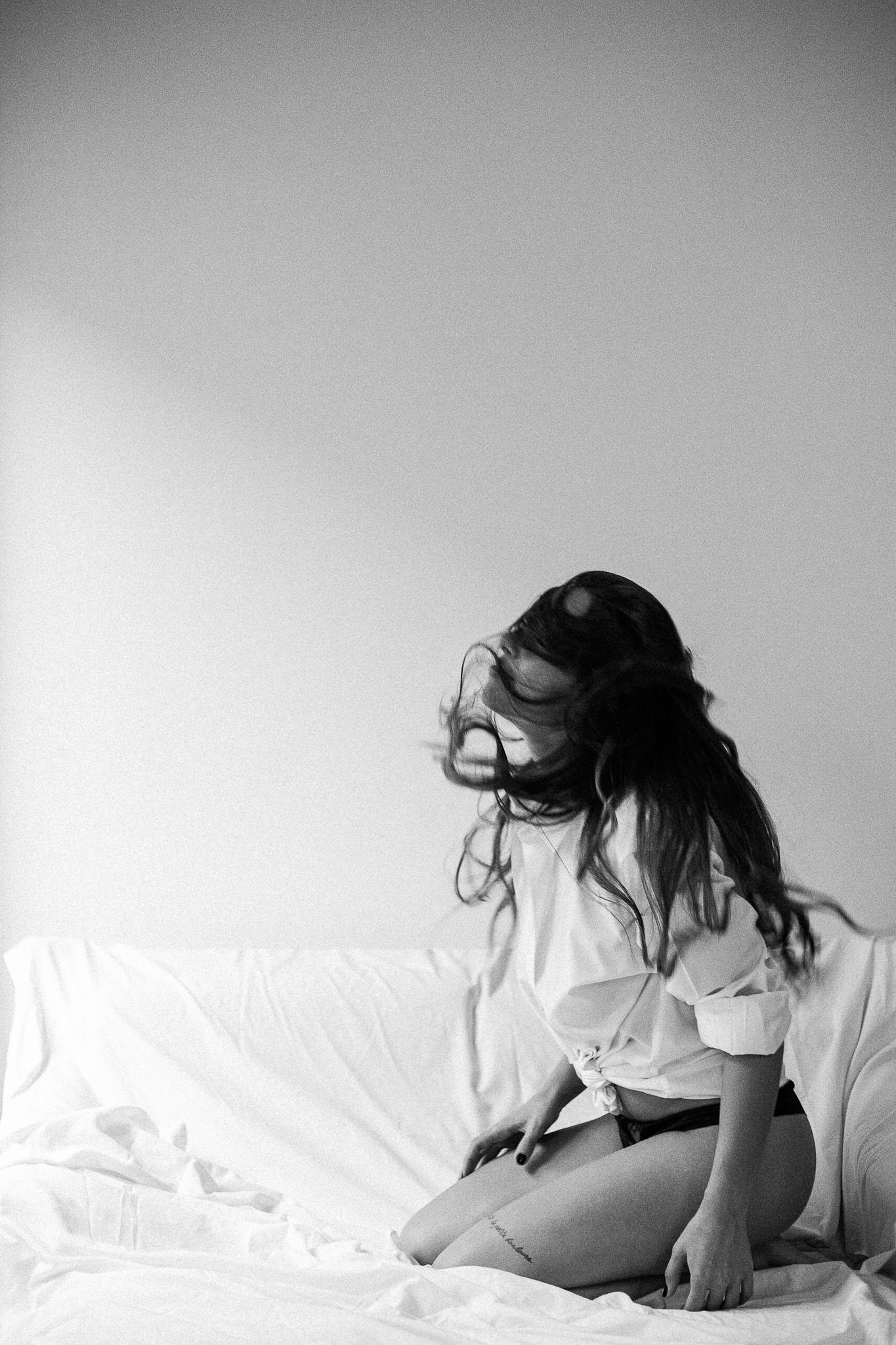 Artistic black and white boudoir series showing natural poses and movement.