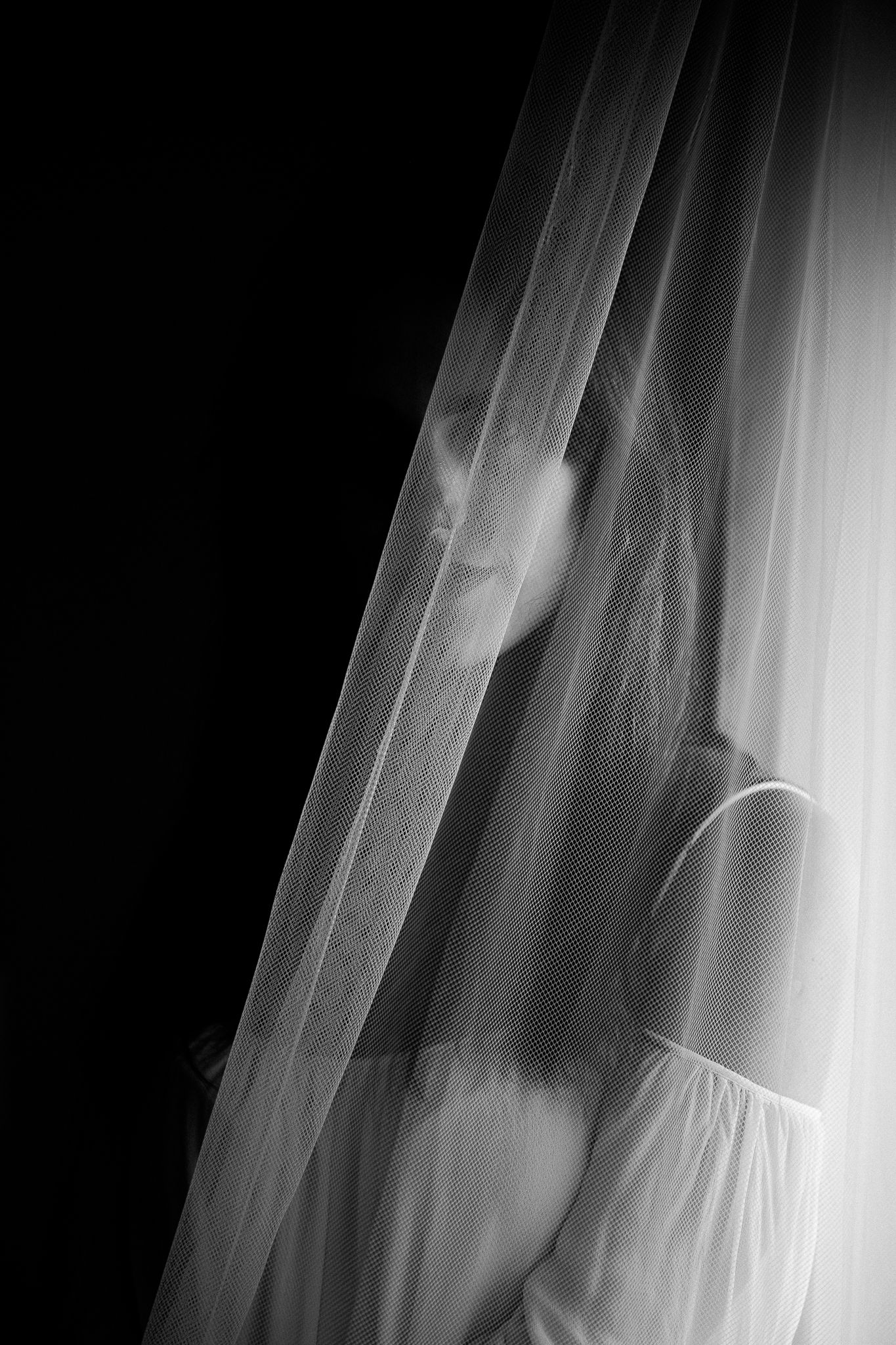 Ethereal black and white motion blur photograph of flowing white fabric creating abstract patterns and textures.