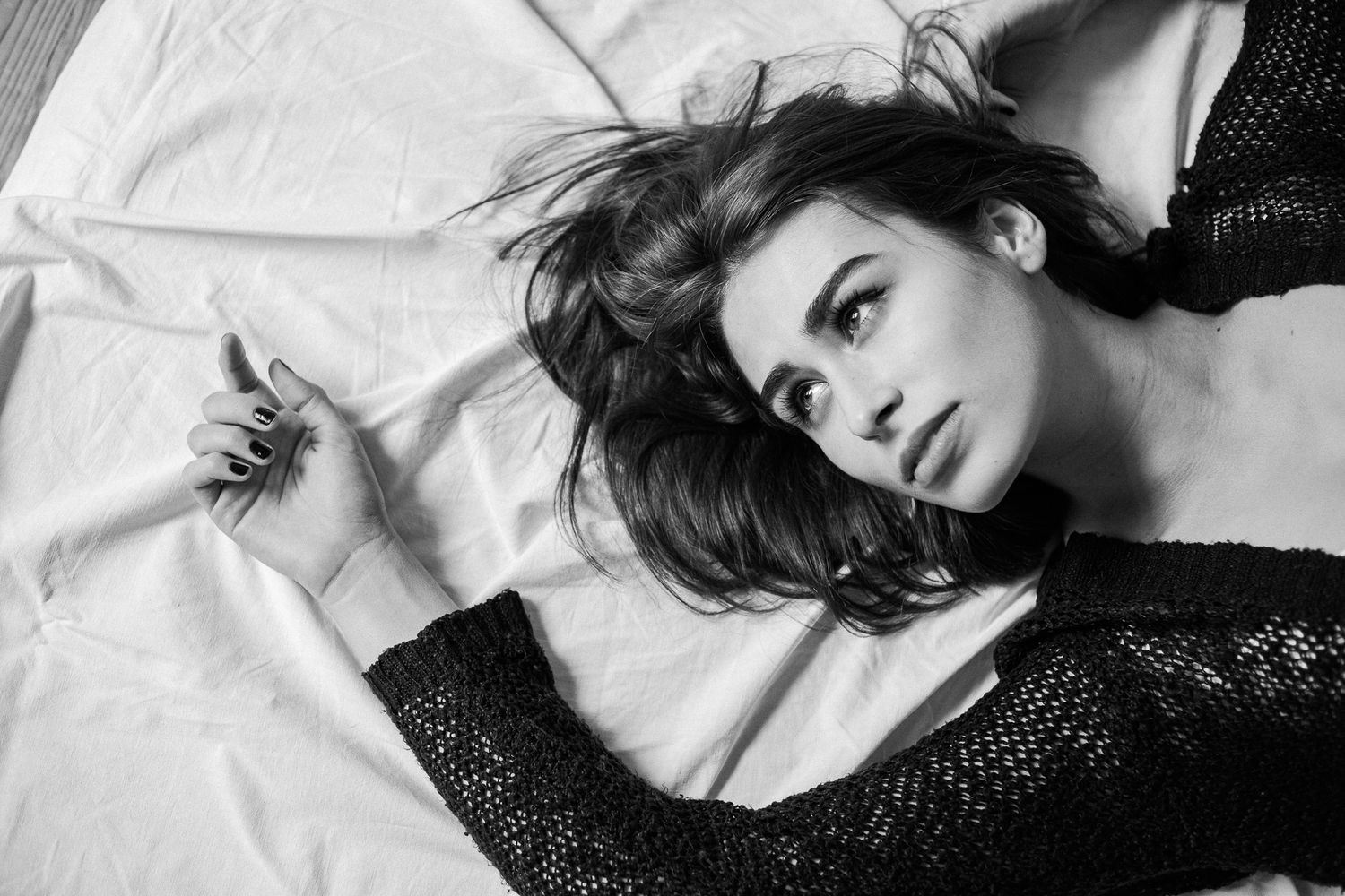 A black and white photo collage shows a person posing in various glamorous reclining positions against light backgrounds.