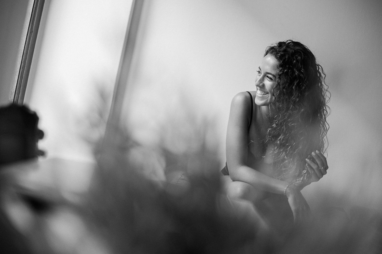 A series of black and white artistic portrait photographs showing a person in moody, atmospheric lighting.