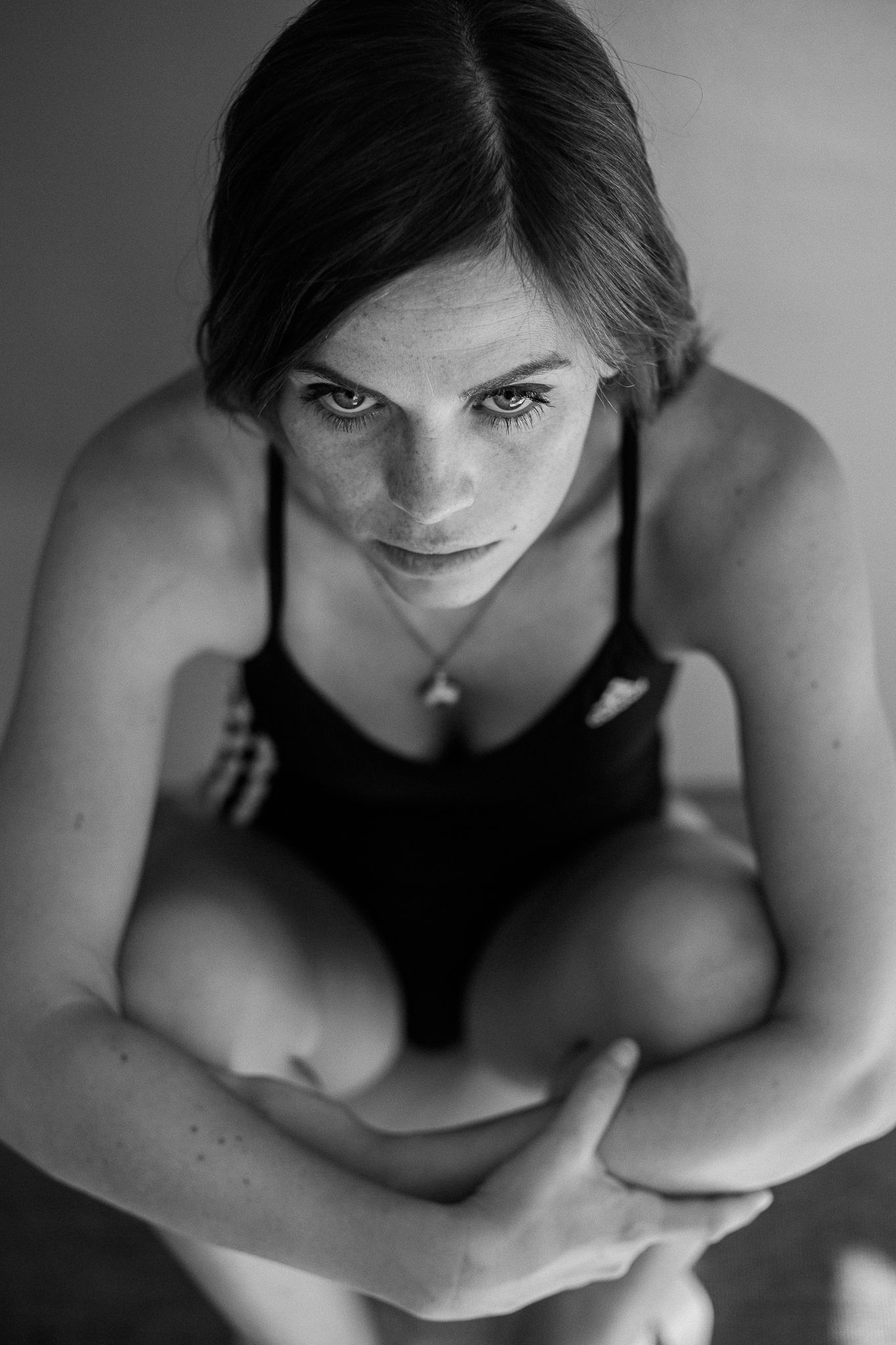 Dramatic black and white portrait series showing artistic angles and shadows in moody lighting.