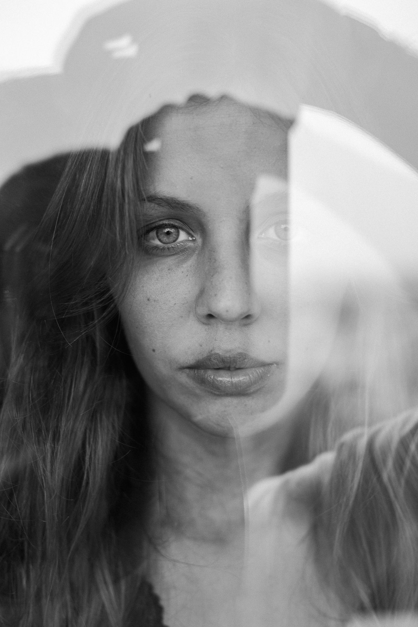 A series of black and white portraits showing close-up views of someone's face from different angles.