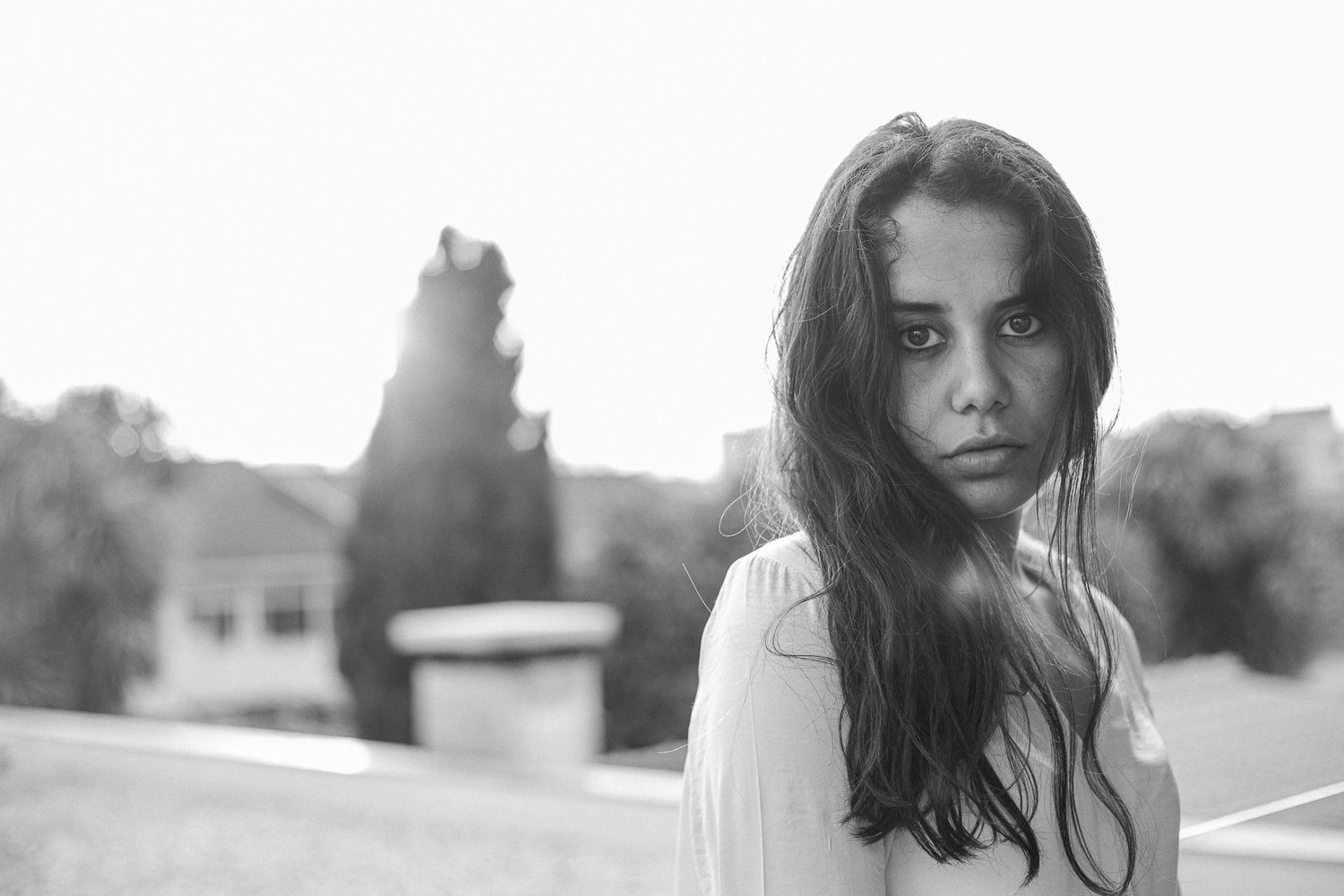 Outdoor portrait series with soft natural lighting and urban architectural elements.