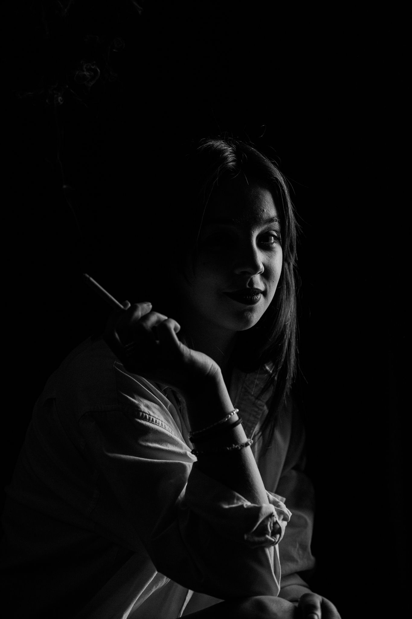 Noir-style portraits in deep shadow with dramatic side lighting.