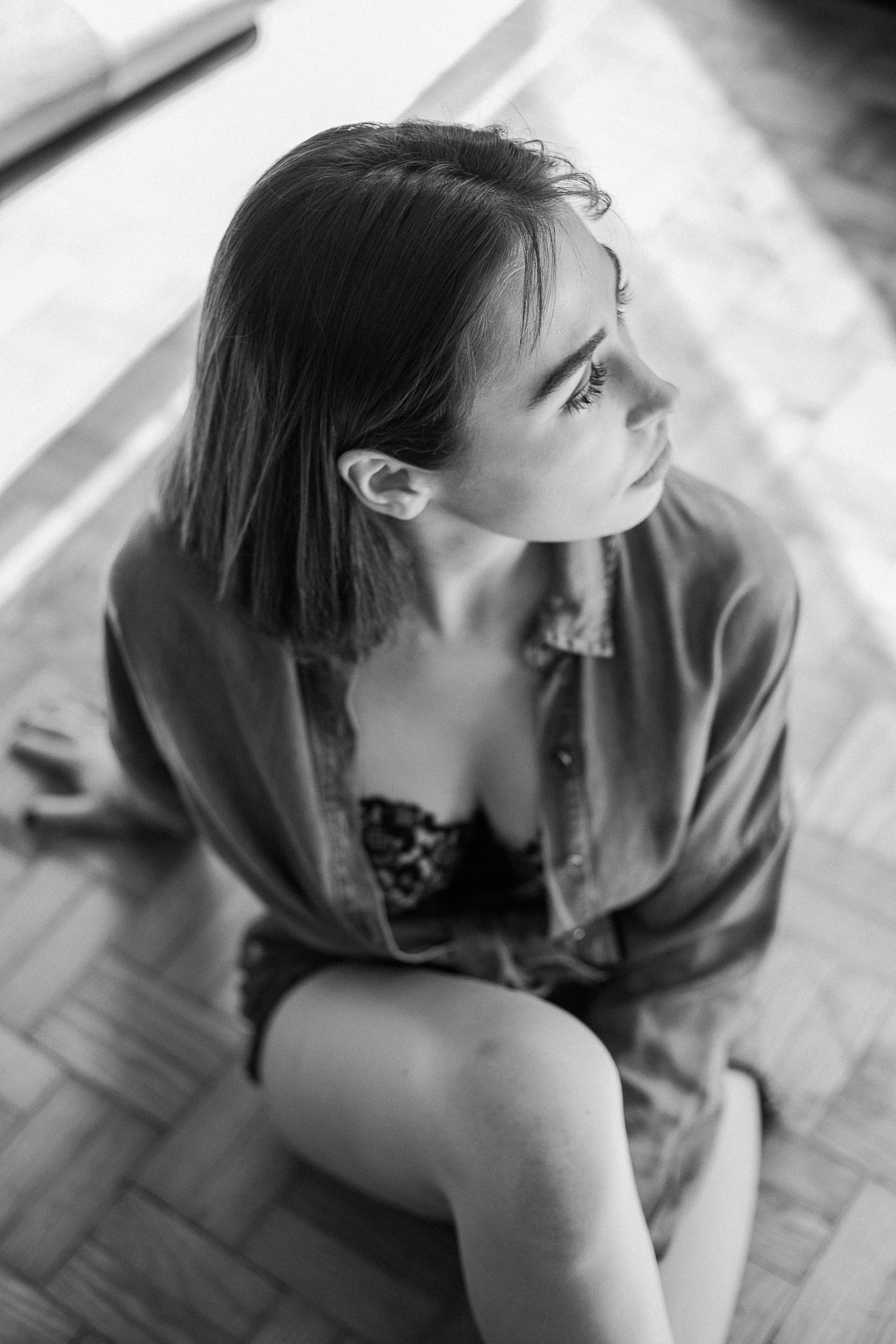 A series of black and white photos showing someone looking upward from different angles in an artistic style.