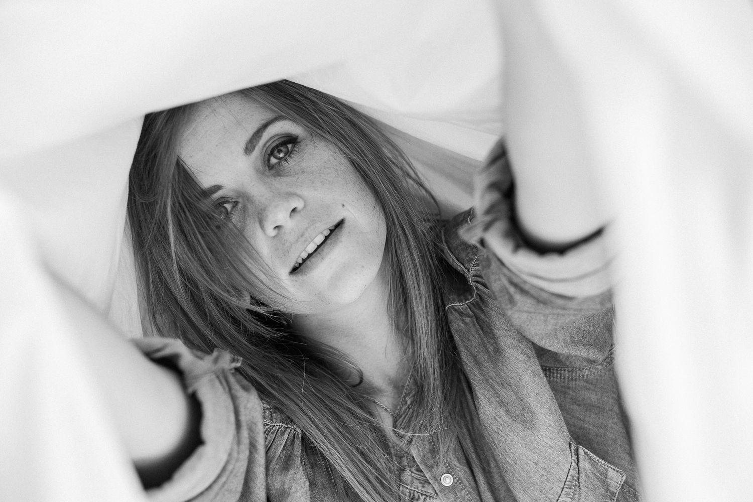 Black and white collage of selfie-style portraits showing someone with long hair in different poses and expressions.