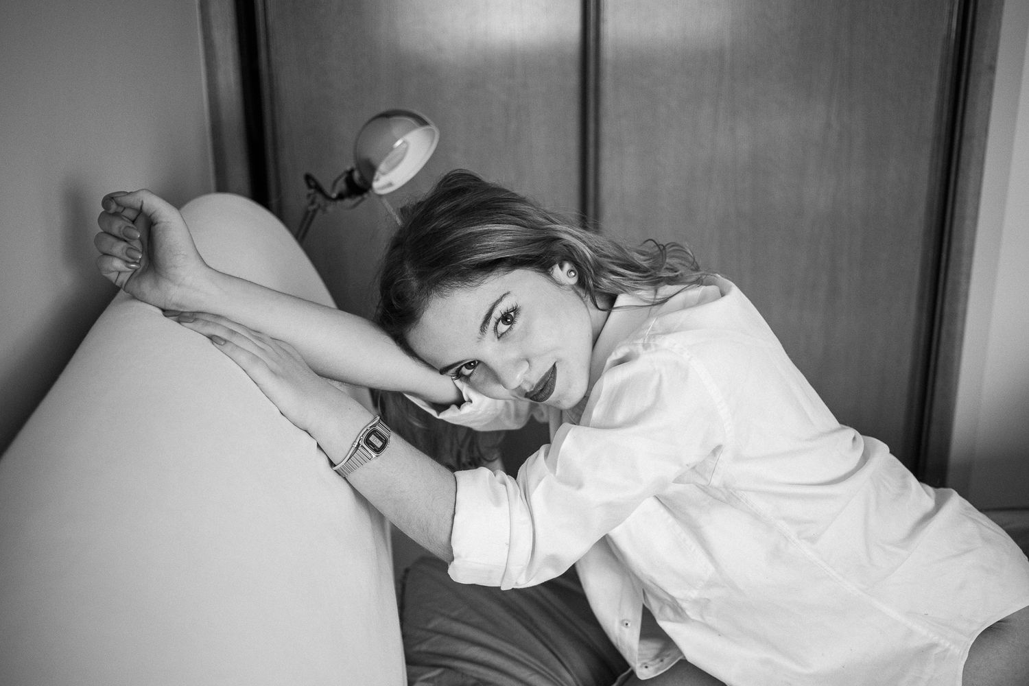 Classic black and white portrait series showing someone reclining in various elegant poses on a sofa.