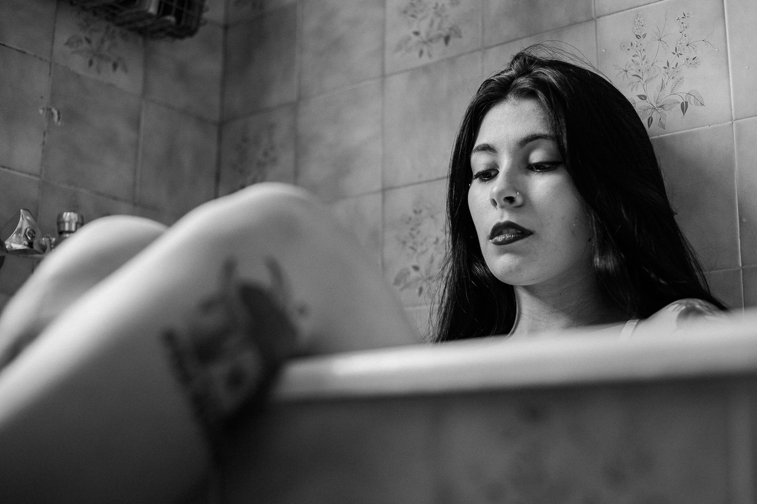 A dramatic black and white photo series showing someone reclining with closed eyes in an artistic pose.