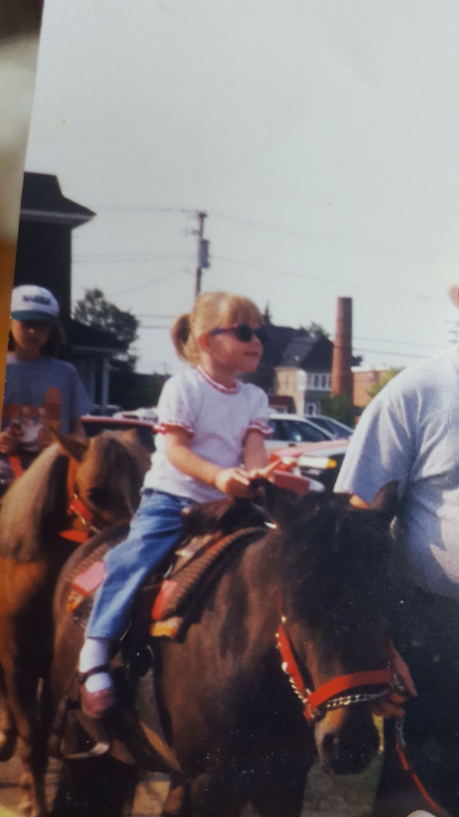 A sequence of photos showing someone riding a brown horse wearing western riding gear at an outdoor event.