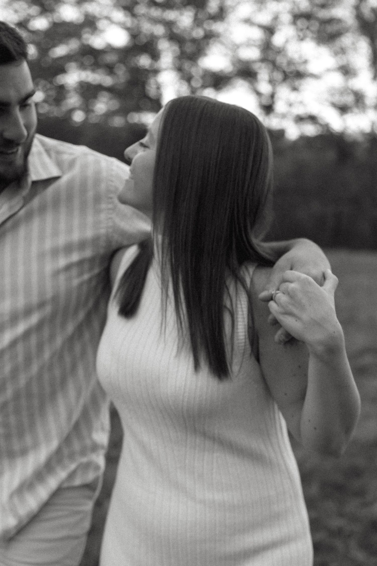 A series of black and white photos showing a person in a white sweater against a blurred outdoor background.