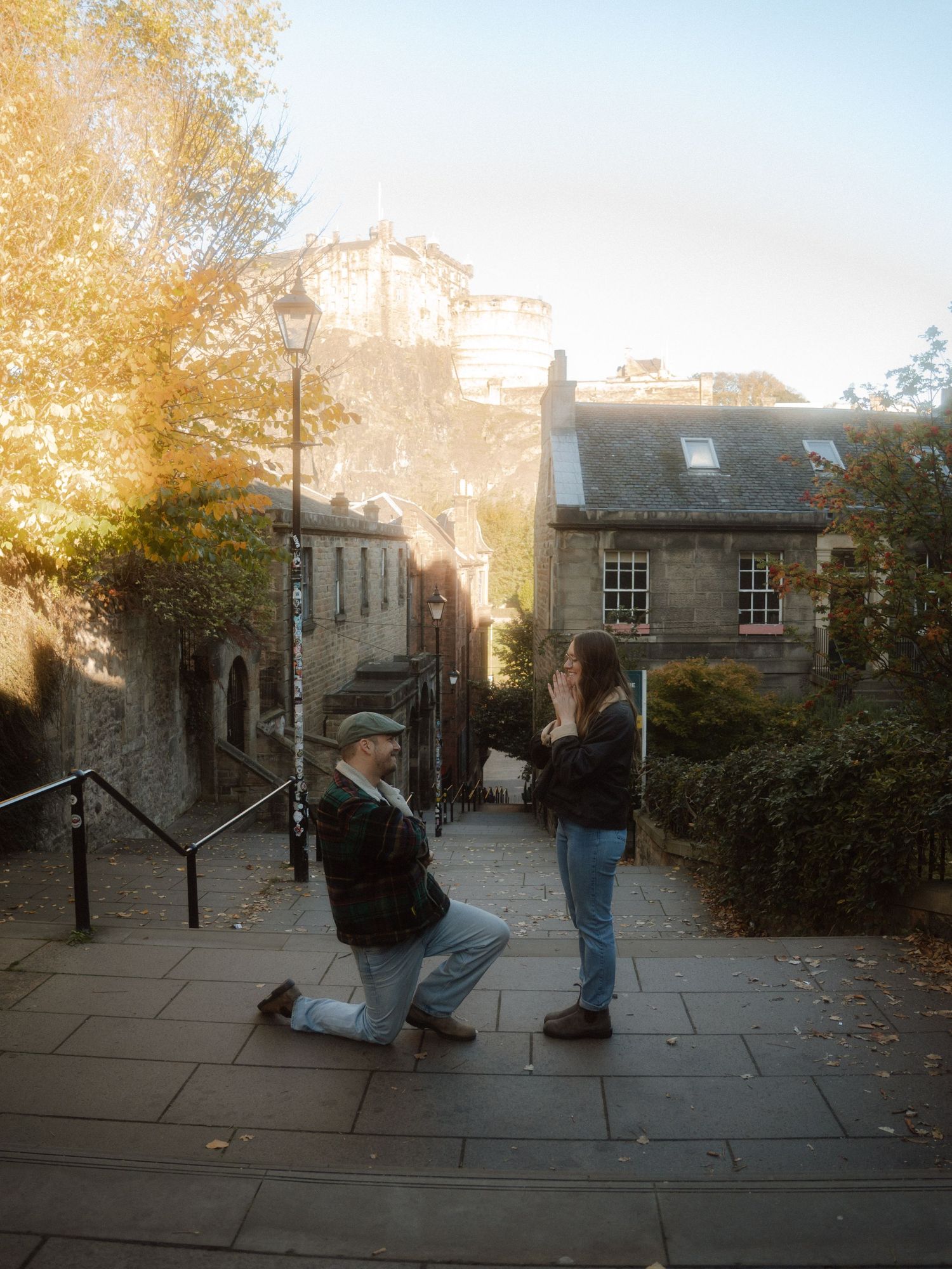 A sequence of images shows people in a street fight, with figures tumbling and scuffling on stone pavement at dusk.