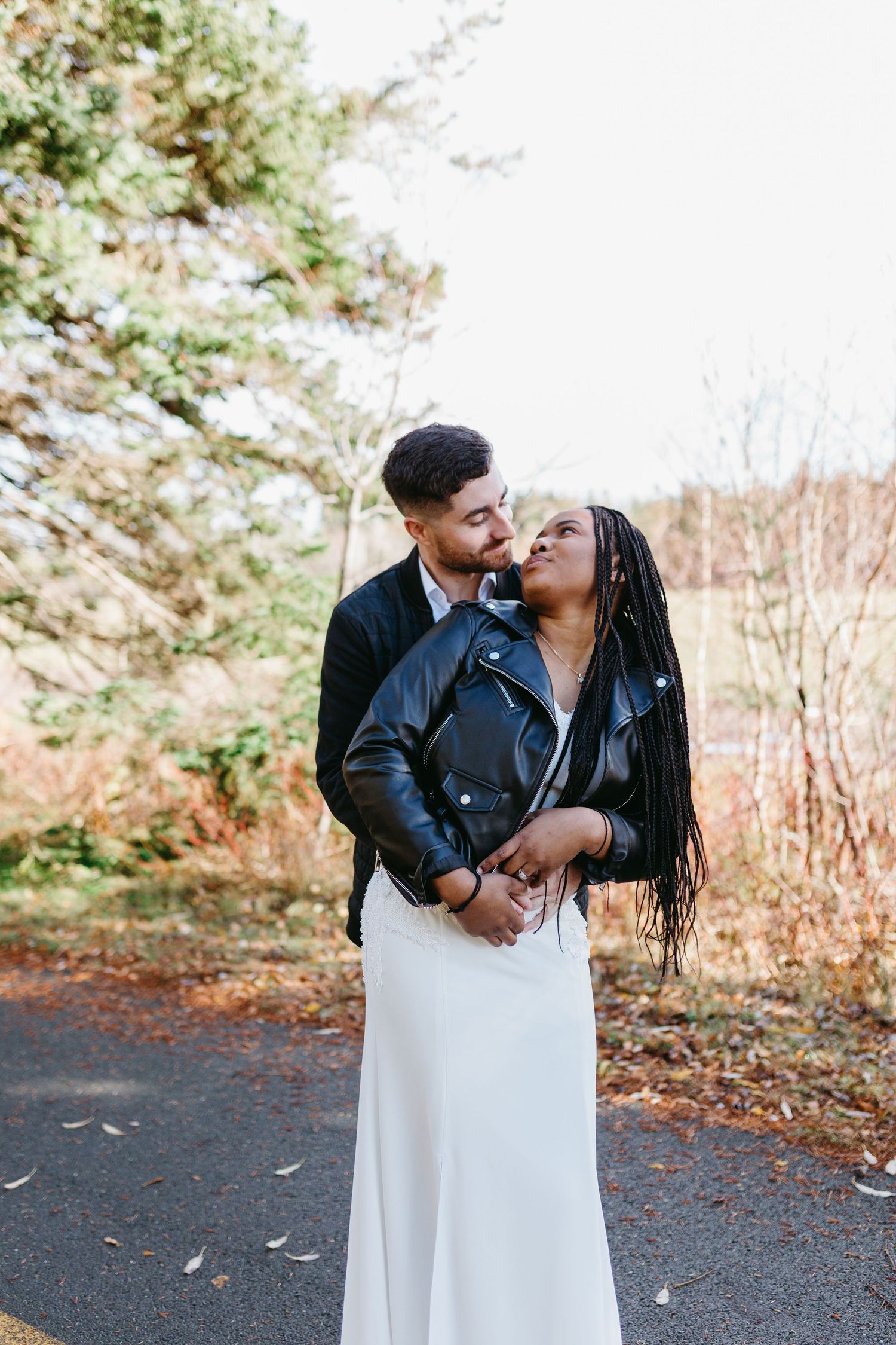 A couple shares an intimate moment together outdoors during a fall photo session in nature.