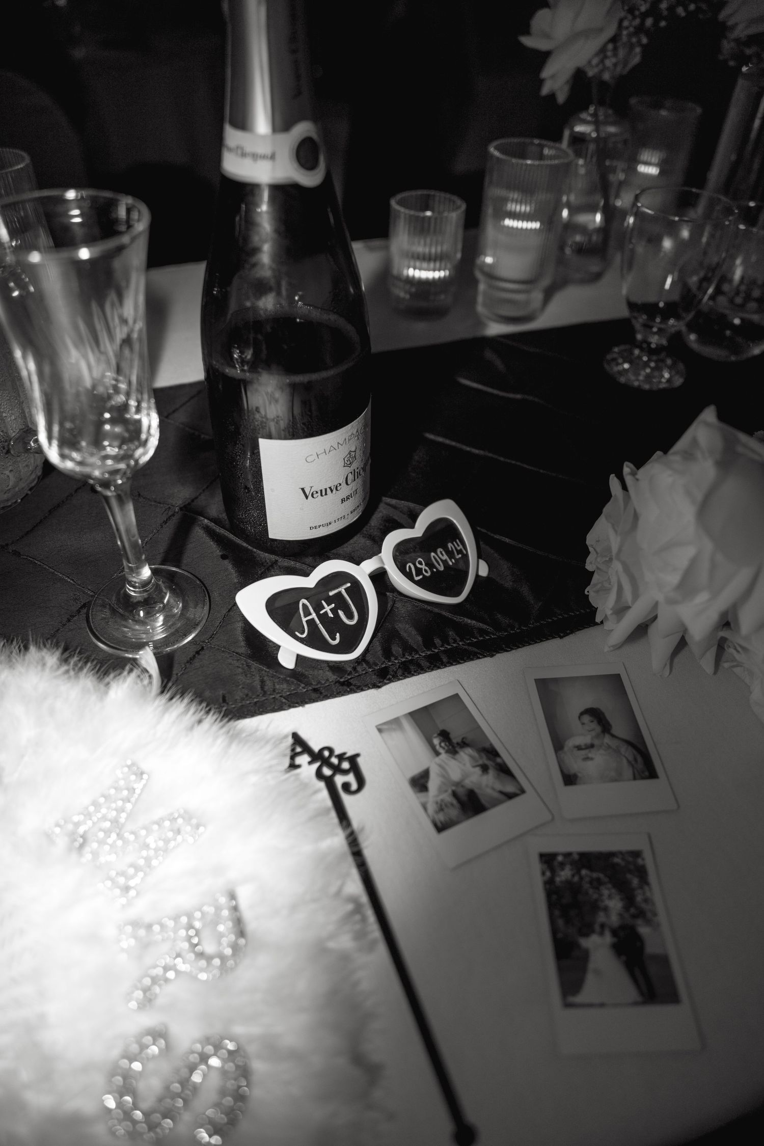 Black and white table setting with wine glasses and decorative elements.