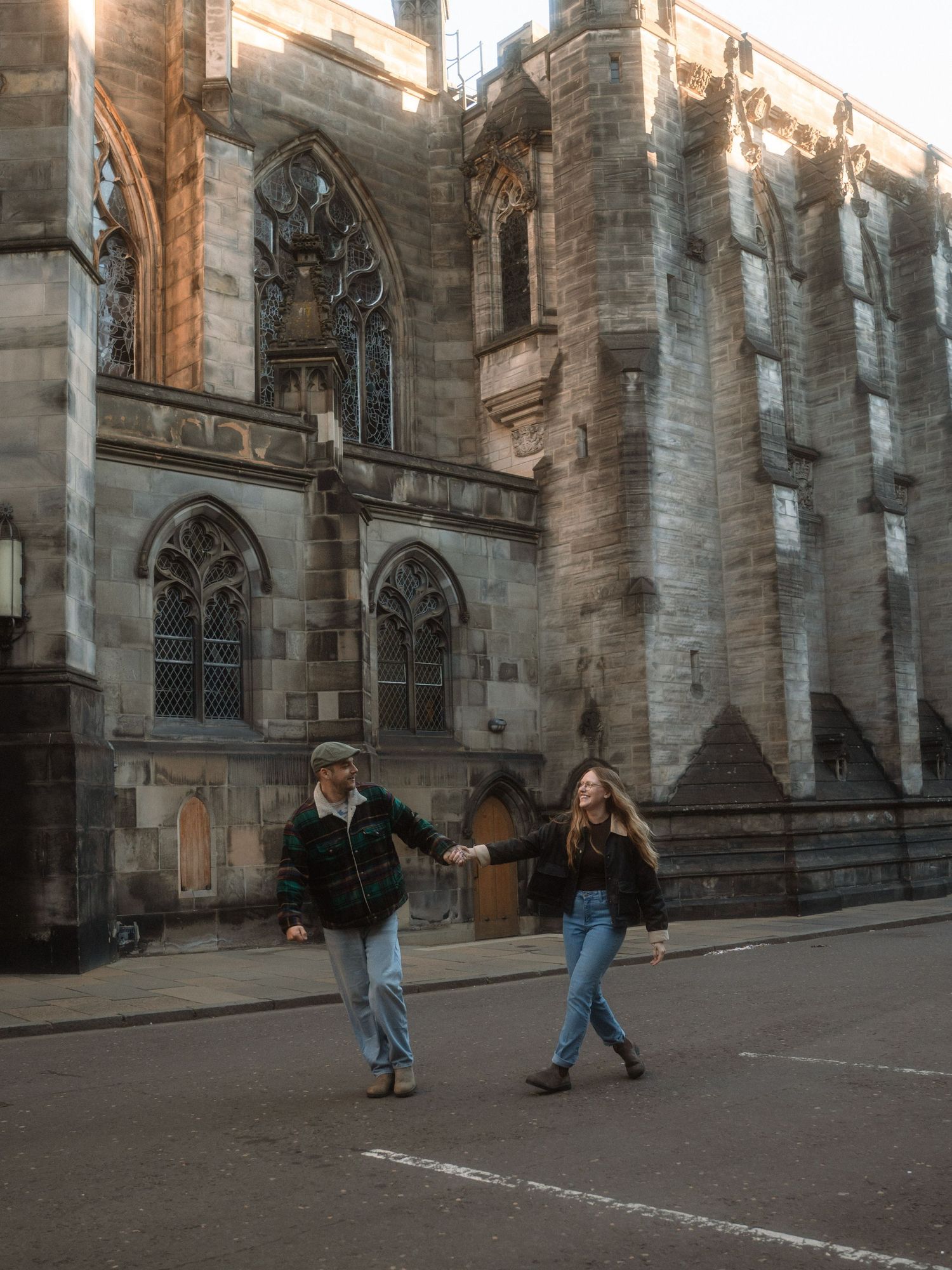 A sequence of four images shows people playing hopscotch on a sidewalk next to a Gothic church building.