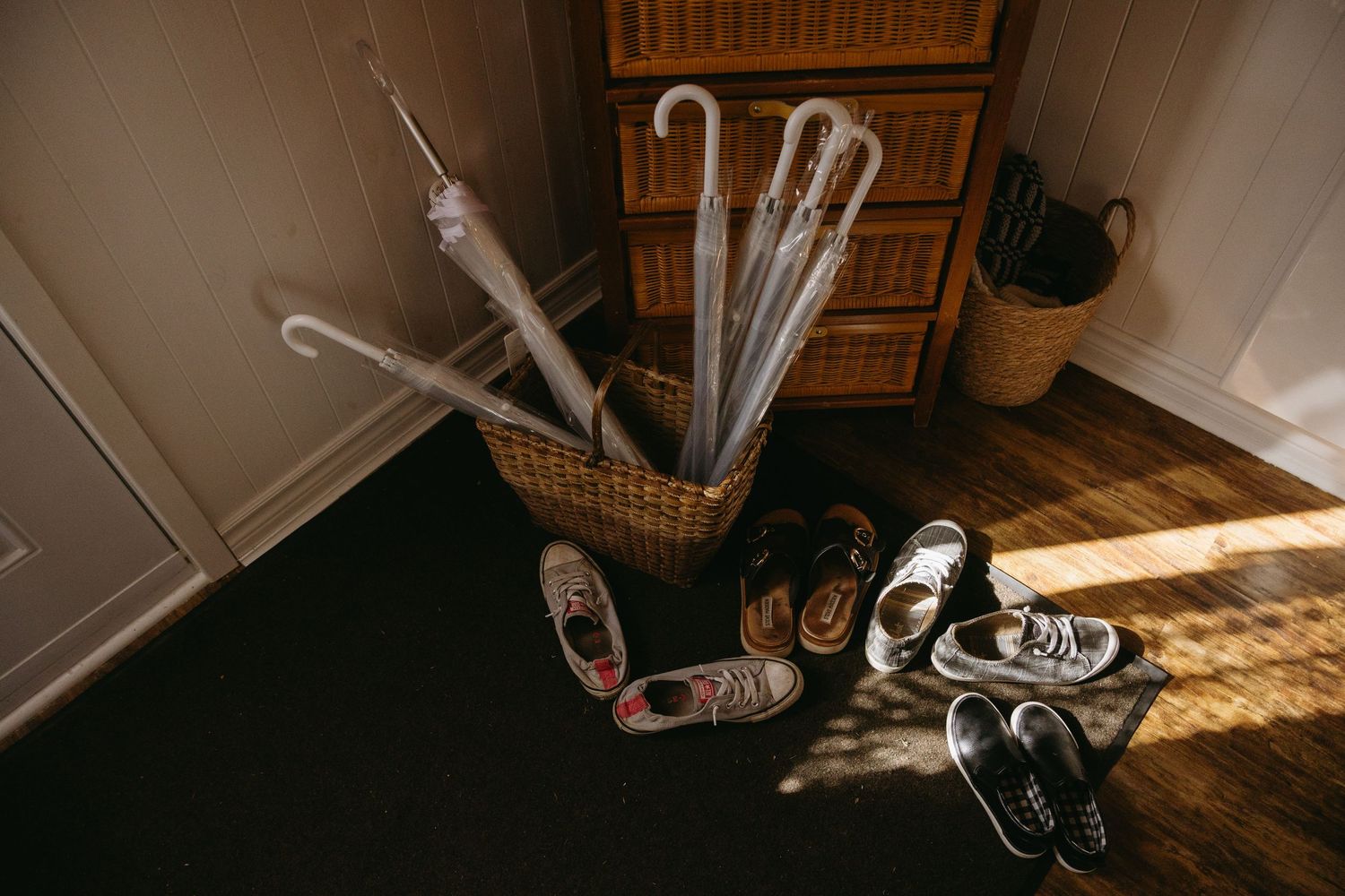 A series of seven connected images showing a person skateboarding down a wooden staircase indoors.