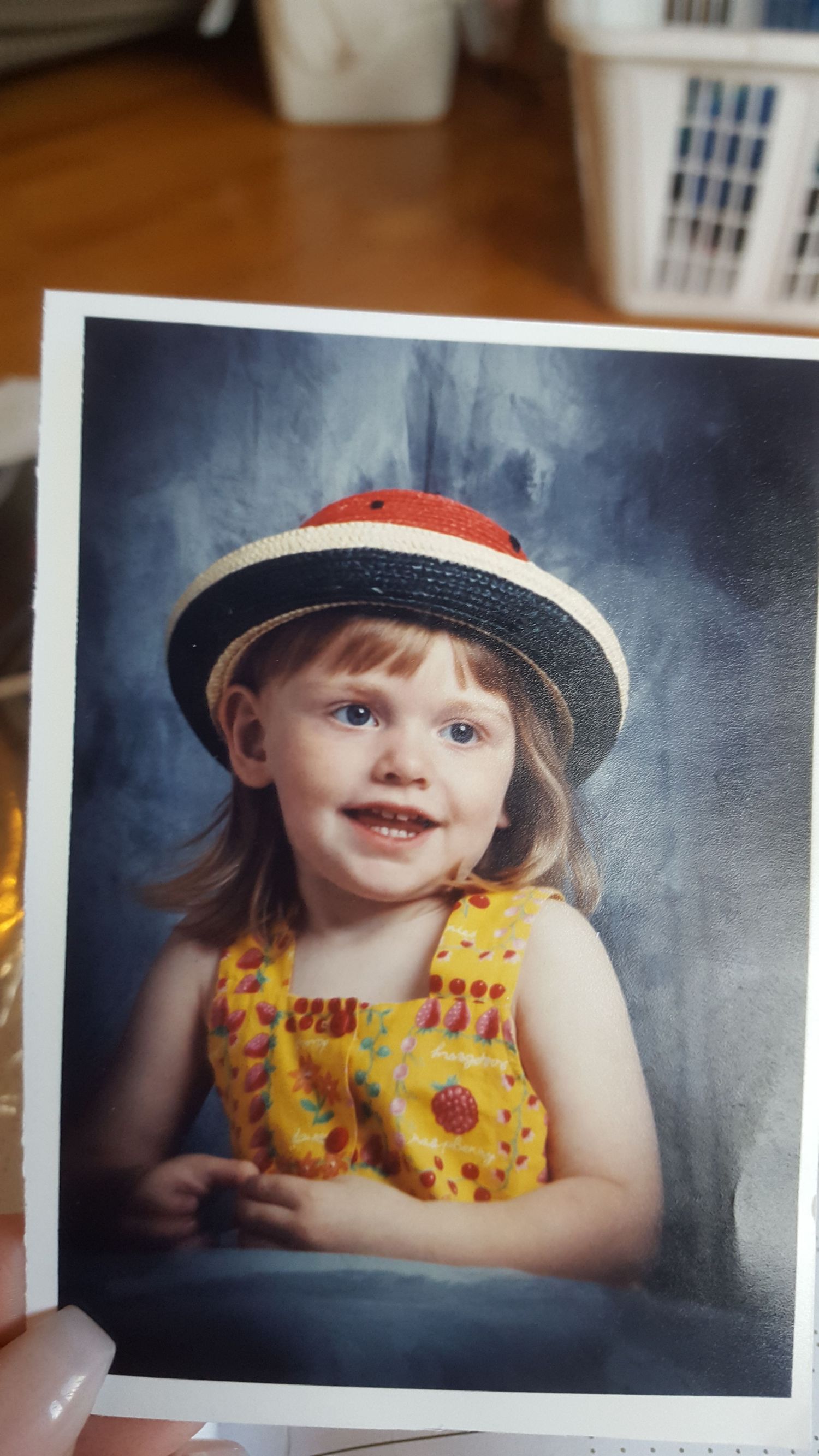 A series of vintage-style photographs showing a child in a red hat and yellow floral dress against a dark background.