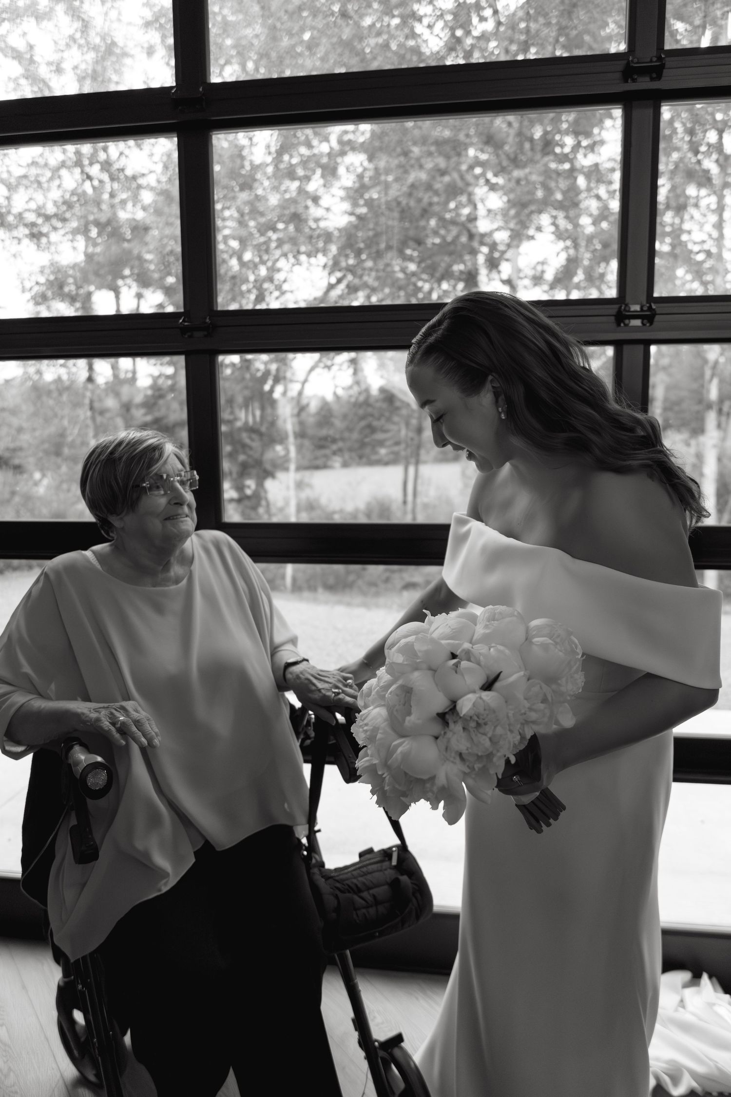 A sequence of black and white photos showing a tender embrace between two people in formal attire.