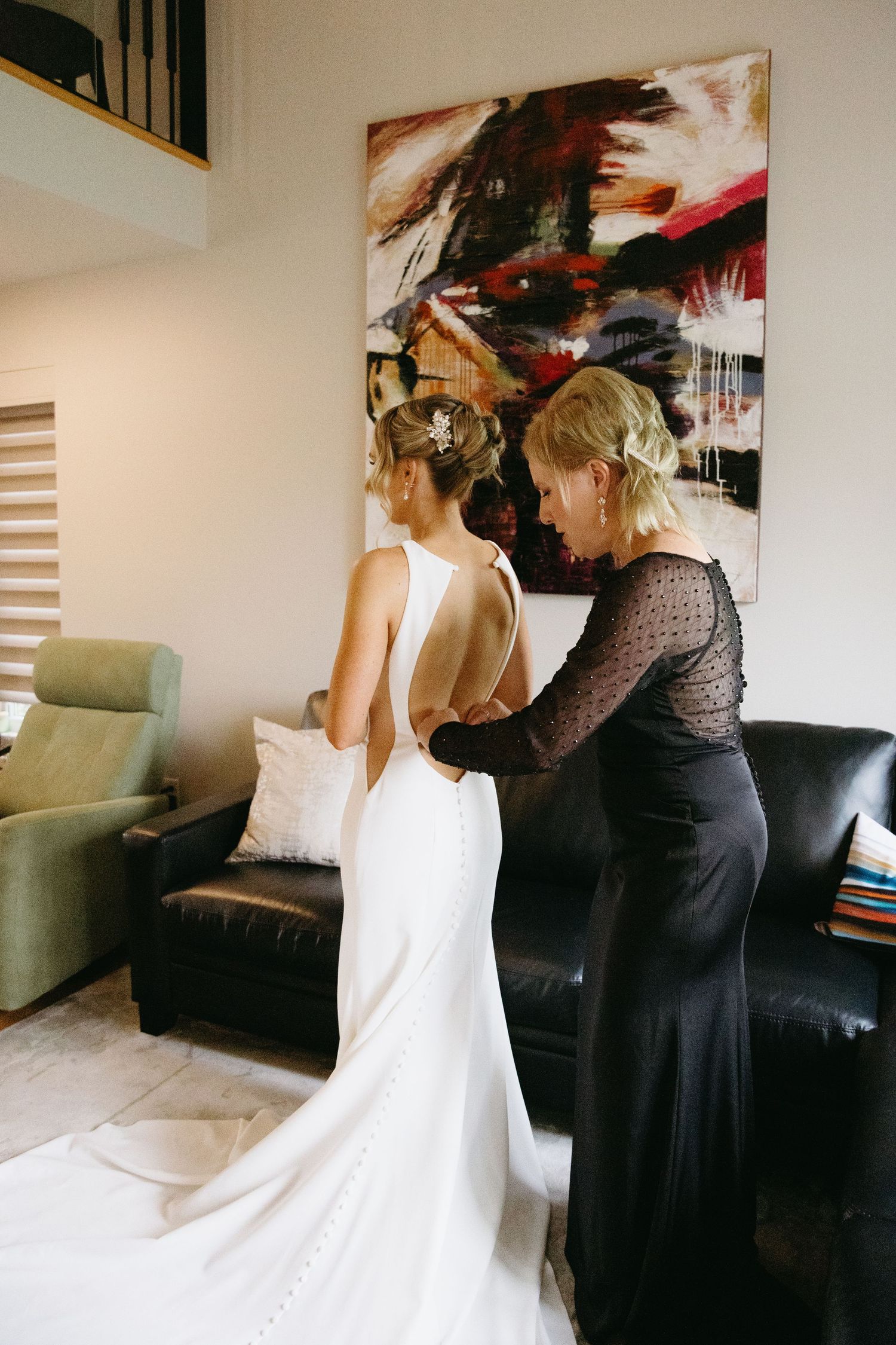 A sequence of motion blur photos showing someone in a white dress being helped with final wedding preparations.