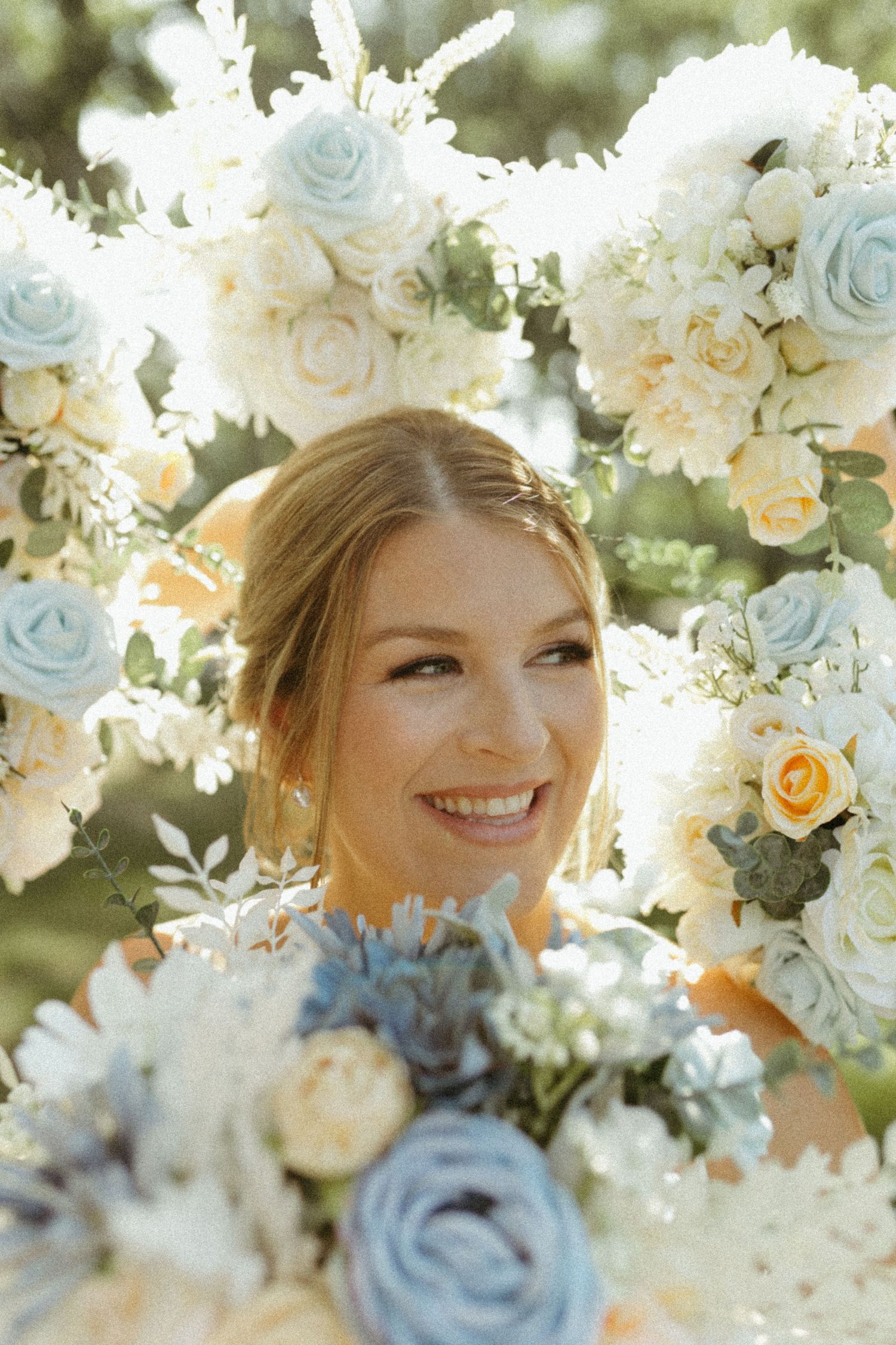 Elegant floral arrangement with pale blue and cream roses creates a romantic wedding backdrop.