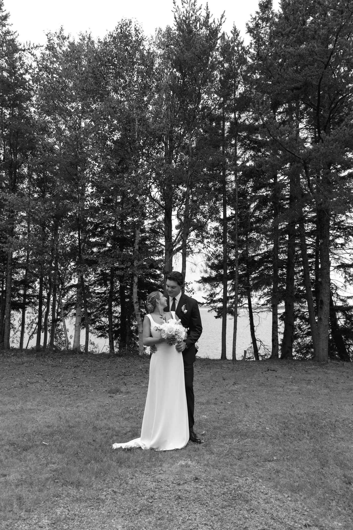 Black and white photos show a couple walking through a scenic pine forest setting.