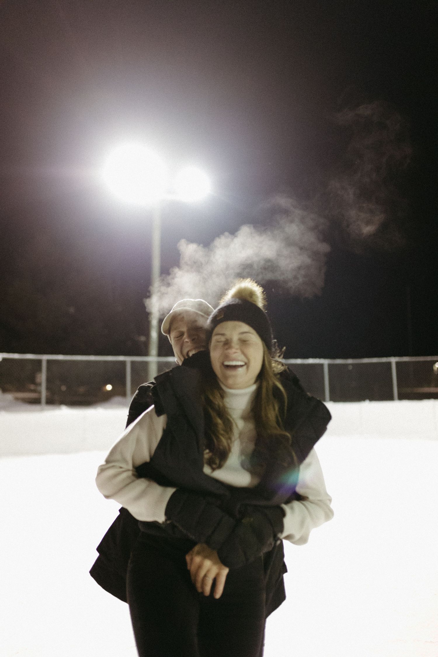 A sequence of motion shots showing someone playing in the snow at night under bright stadium lights.