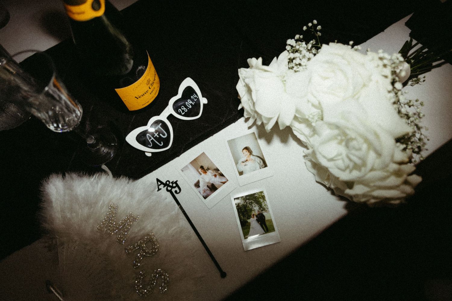 A collection of dark moody photos featuring white flowers, keys, and decorative elements arranged on a surface.