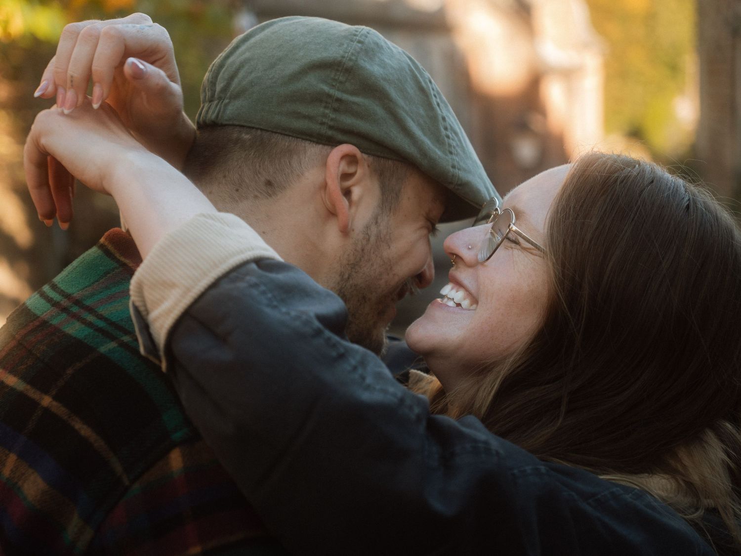 Romantic couple sharing tender moments in a series of candid outdoor photos at sunset.