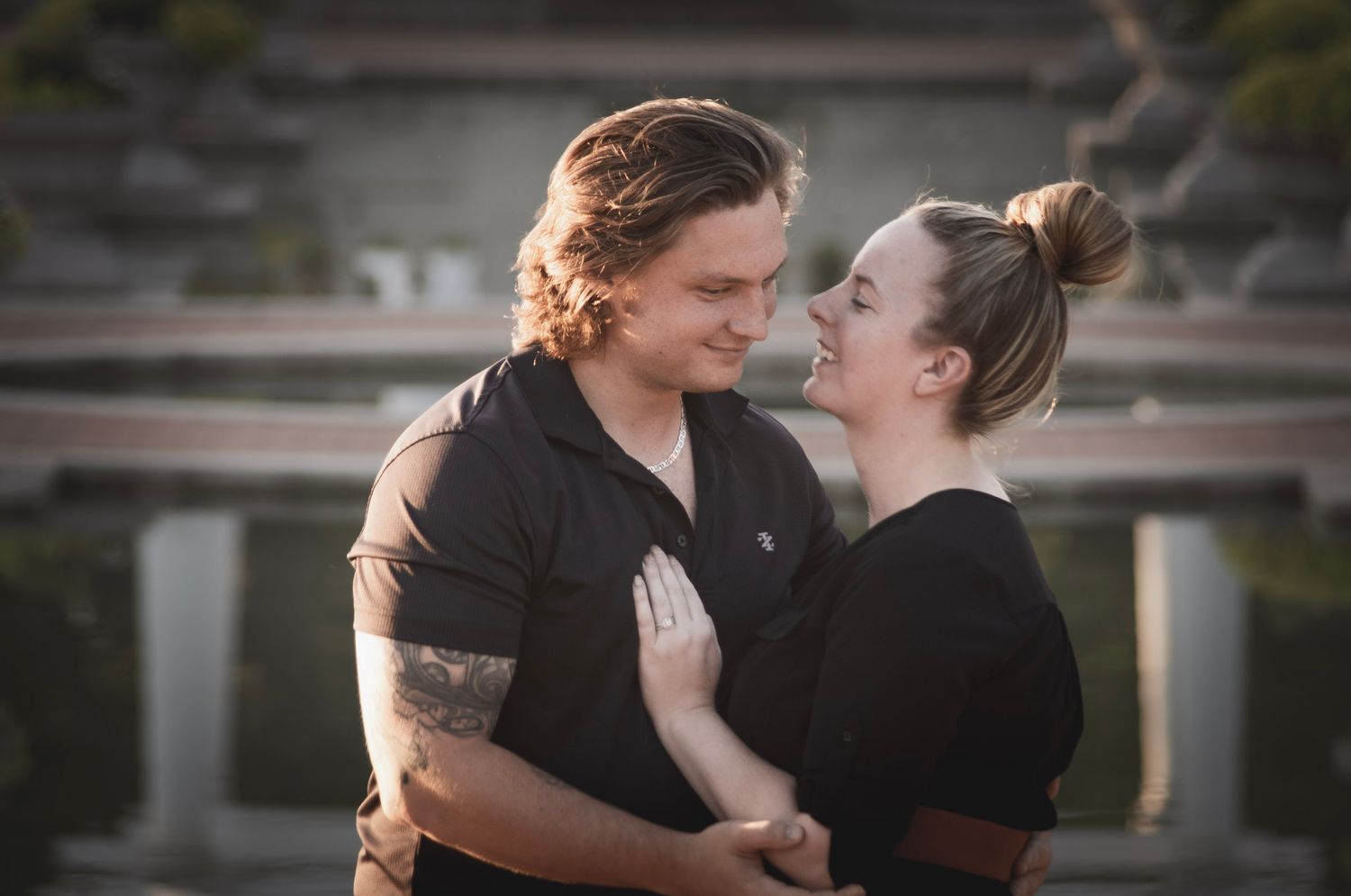 Romantic lifestyle photography of a couple hugging outdoors