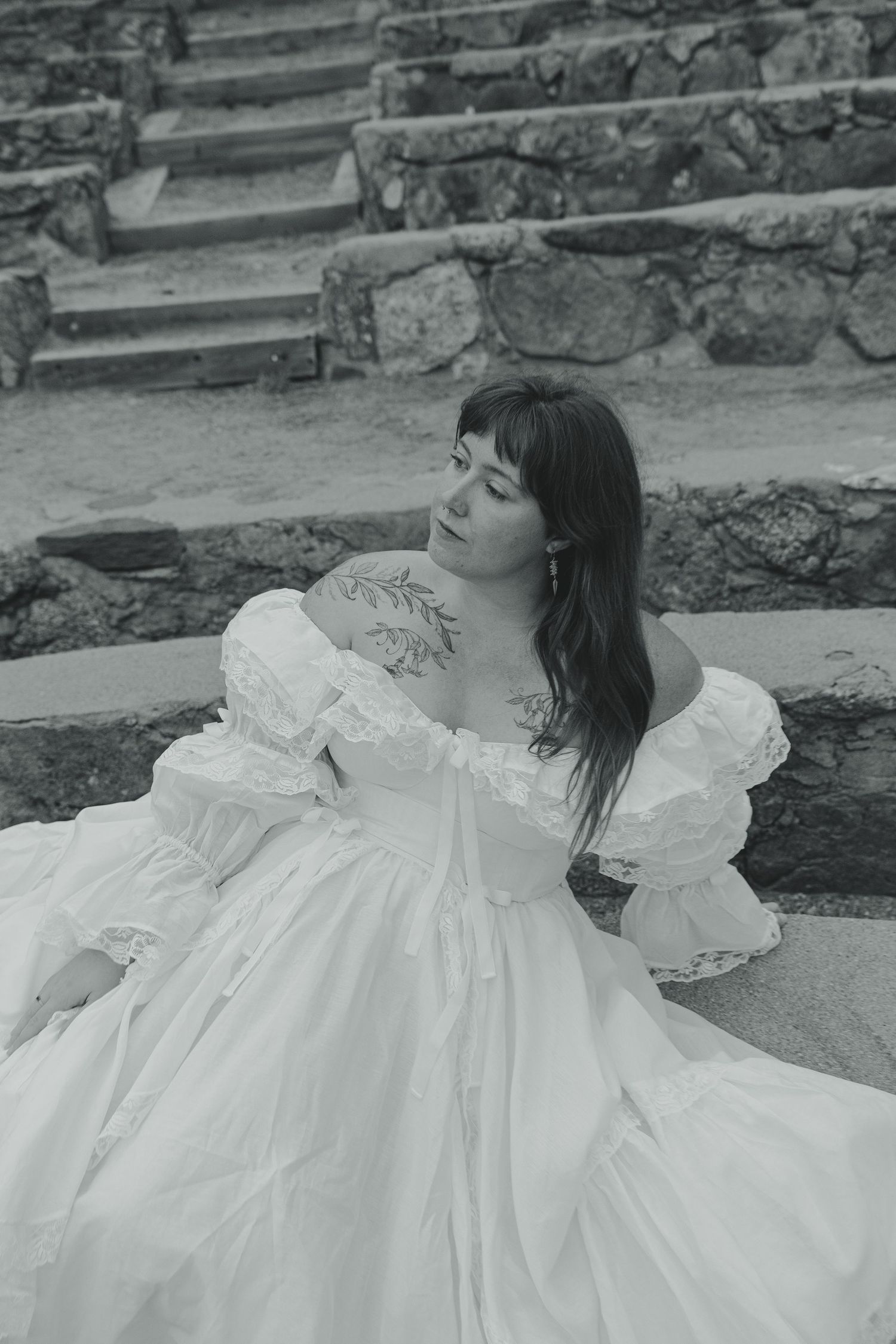 Lifestyle portrait of Shay Godfrey in their wedding dress surrounded by Colorado nature