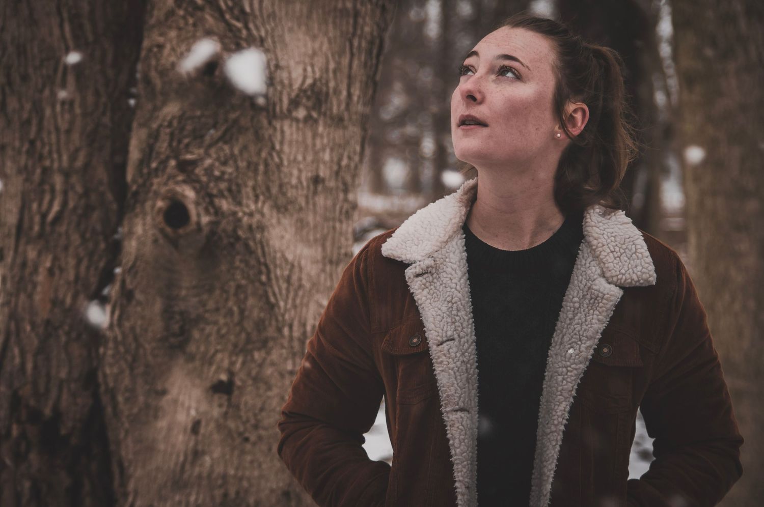 Outdoor portrait in the snowy woods capturing candid emotions and awe