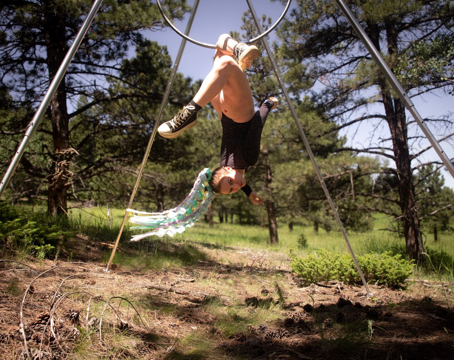Shay Godfrey capturing a performer on the Lyra surrounded by Colorado wilderness