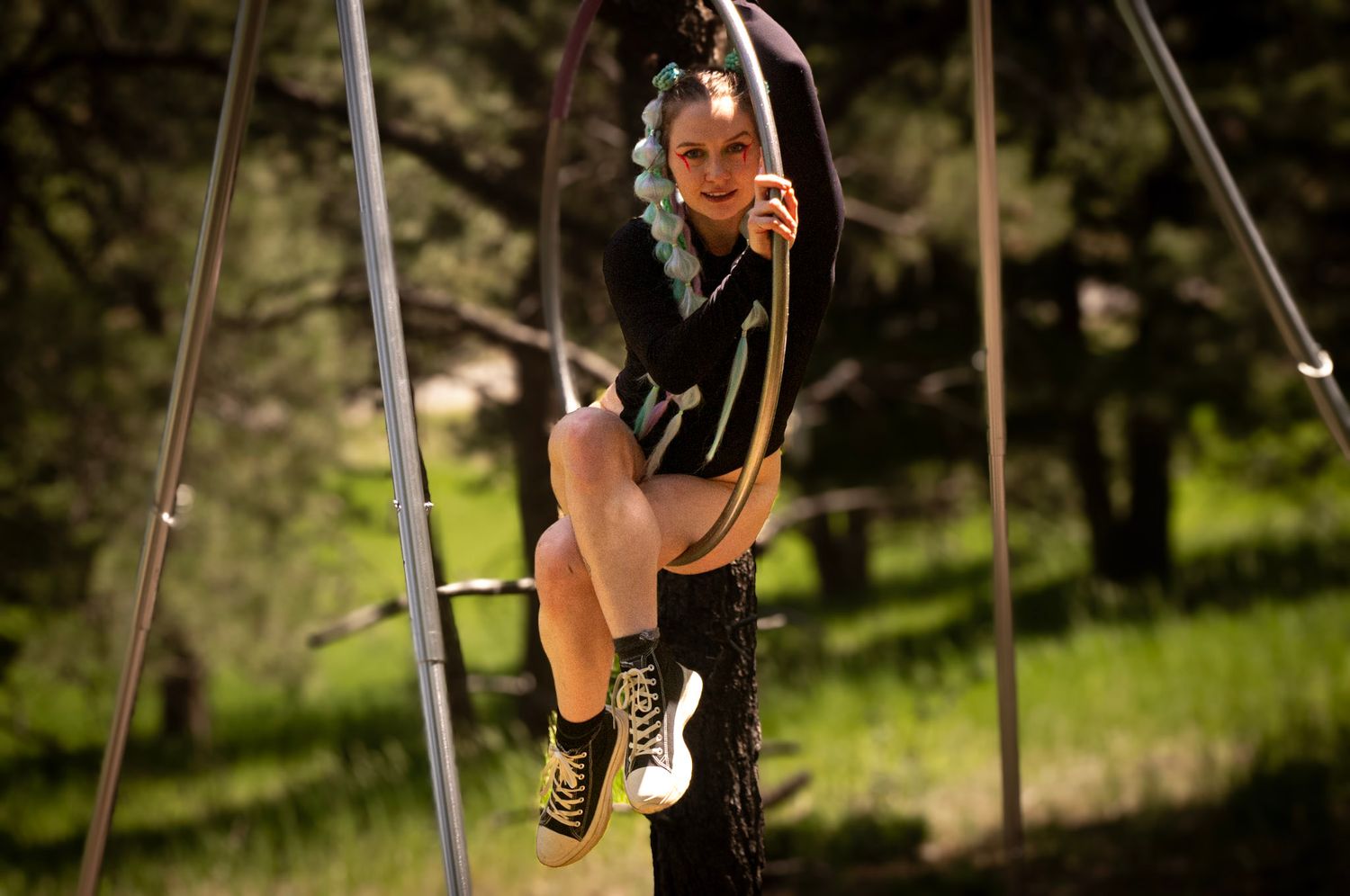 Shay Godfrey capturing a performer on the Lyra surrounded by Colorado wilderness