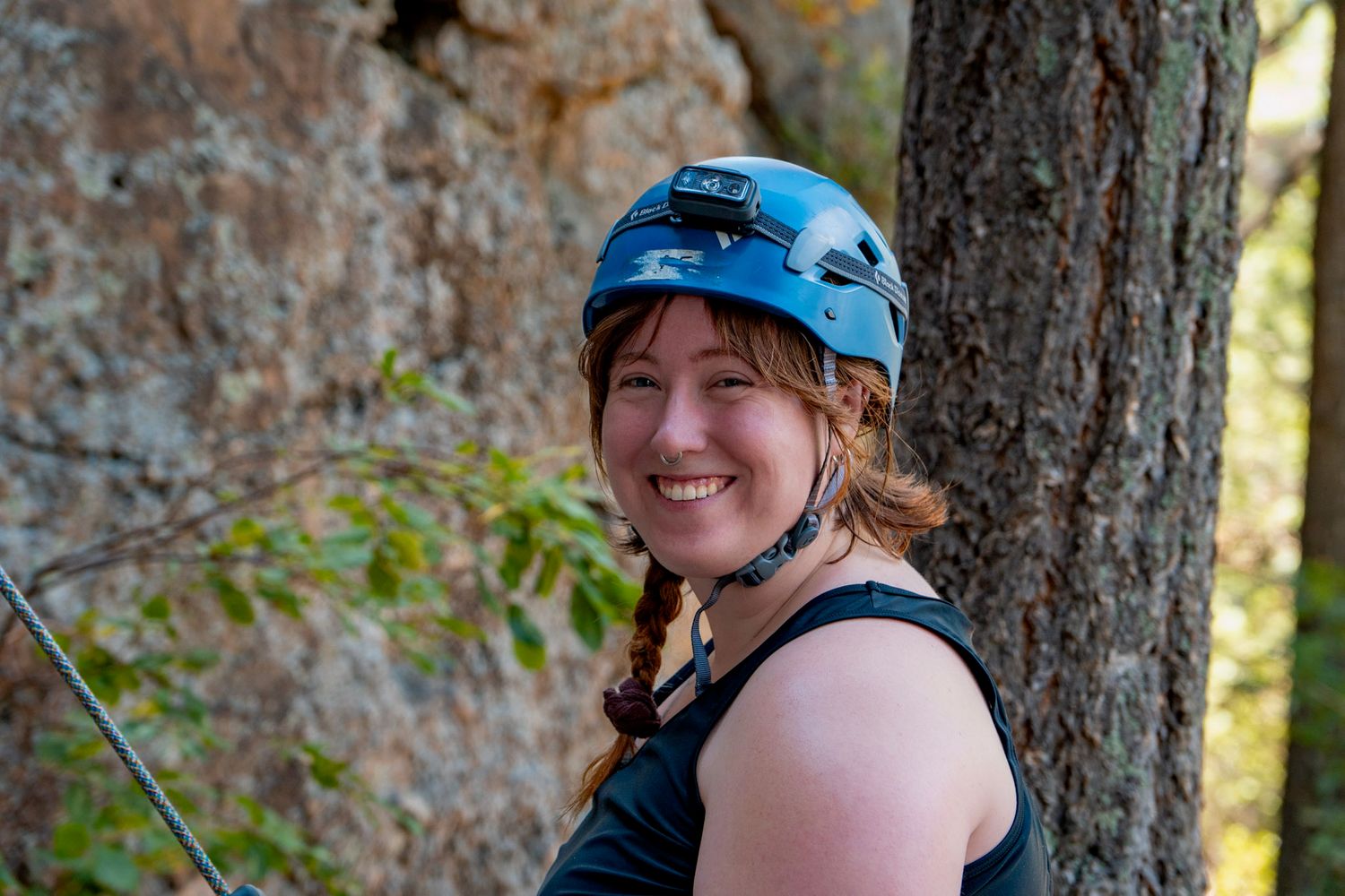 Photographer Shay Godfrey in climbing gear on a Colorado mountain trail