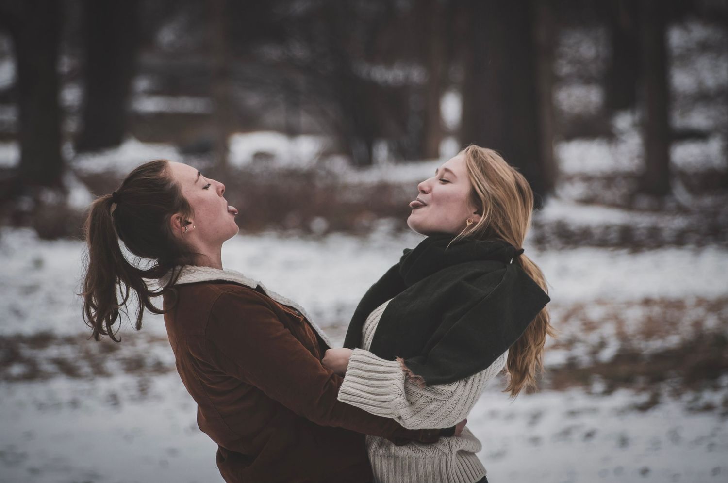Shay Godfrey capturing a loving, authentic moment between a queer couple sticking their tongues out at each other outdoors