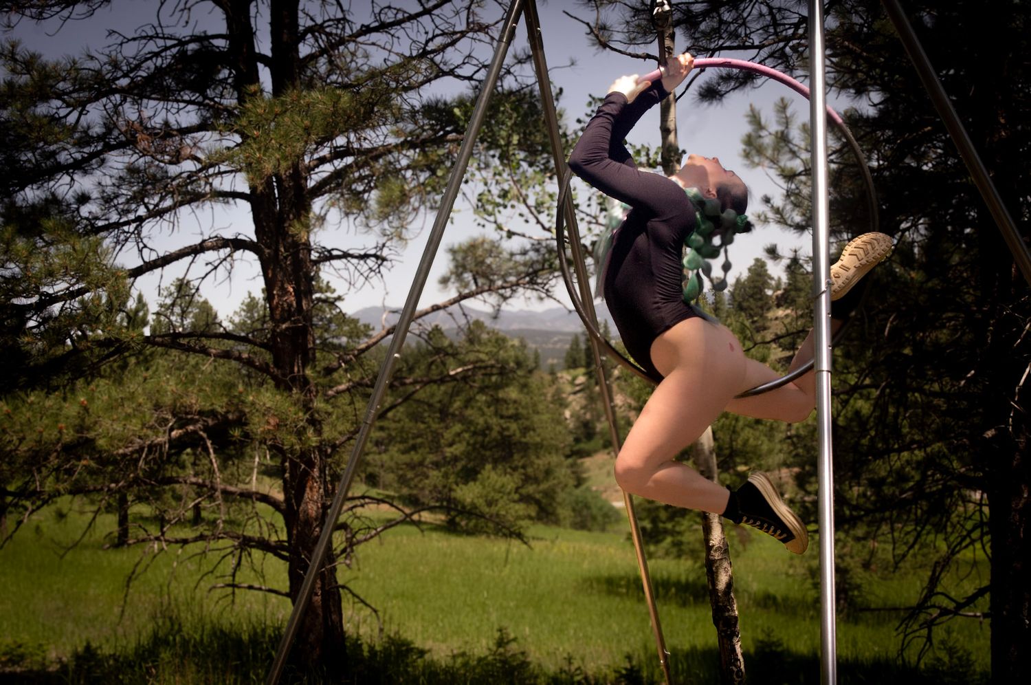 Shay Godfrey photographing an aerial performer on the Lyra outdoors in Colorado wilderness