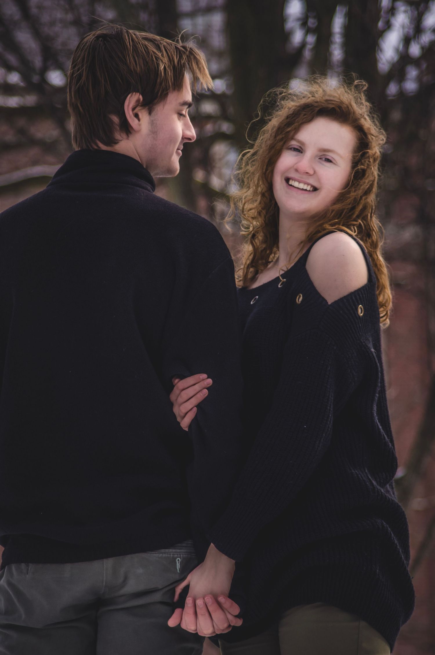 Romantic lifestyle photography of a couple hugging outdoors in the woods