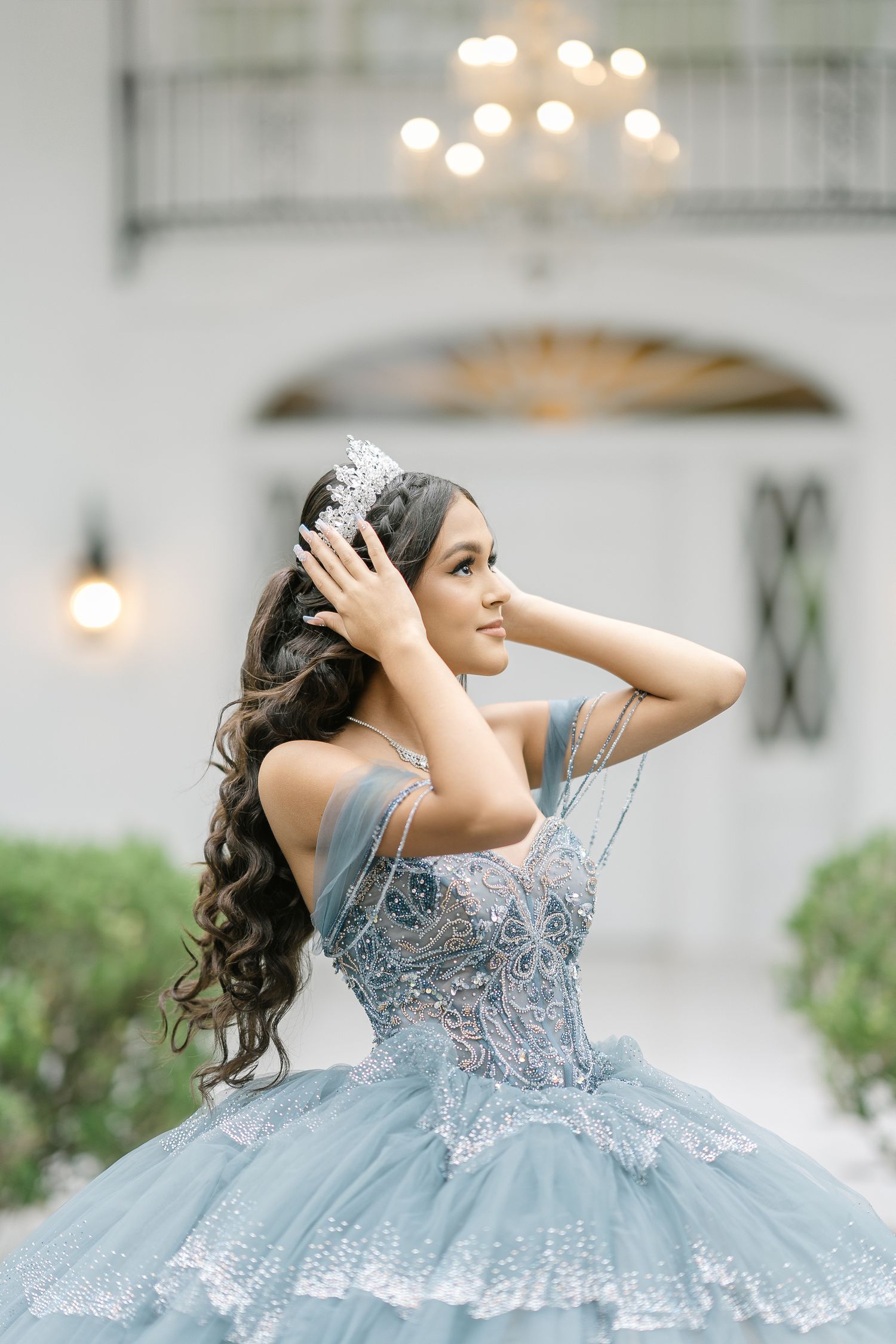 Elegant light blue ballgown with silver embellishments captured in romantic portrait session.