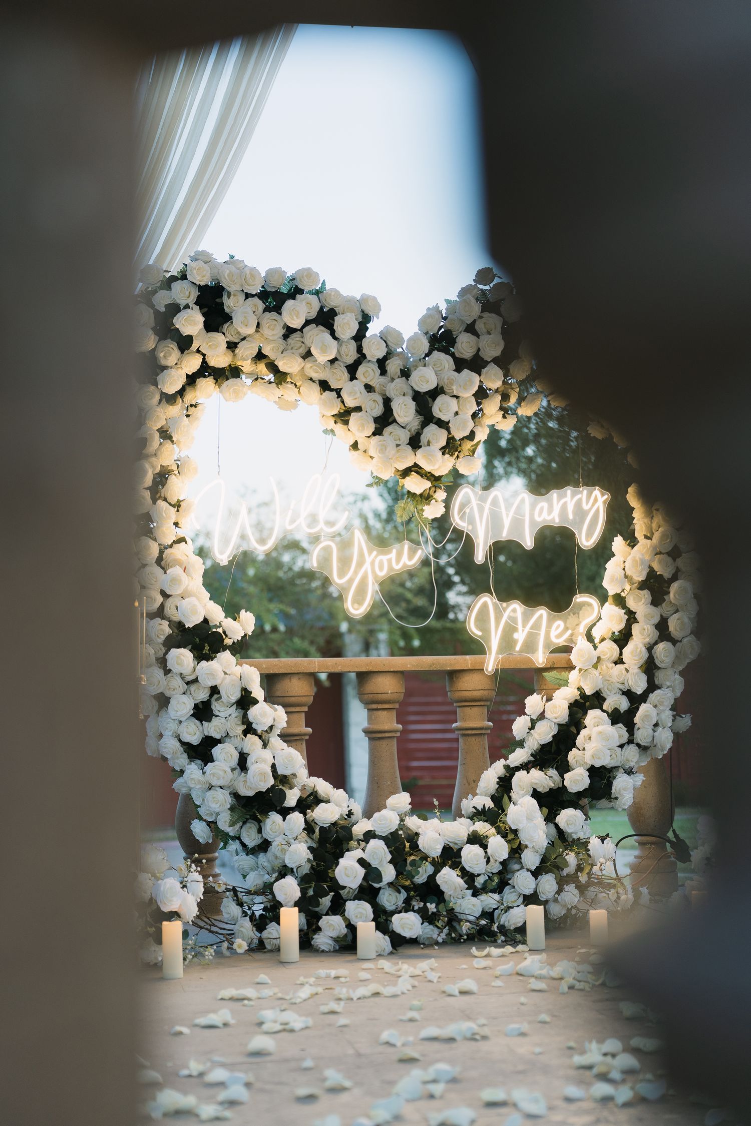 Heart-shaped floral arch with white roses and neon 