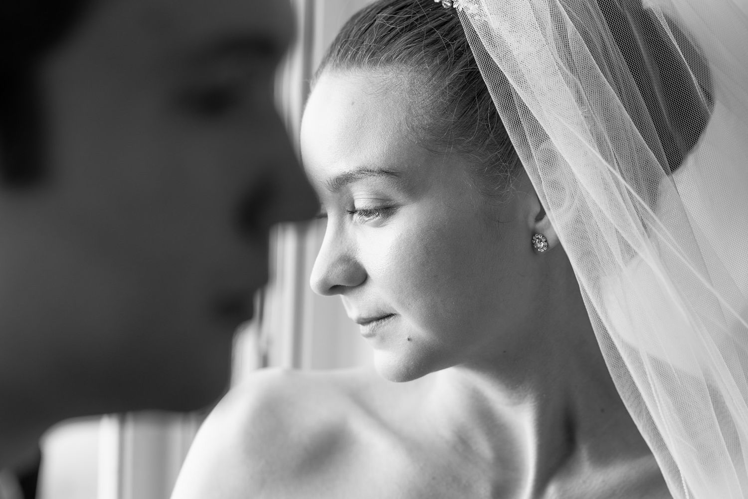 Black and white portrait shots of bride wearing delicate veil.
