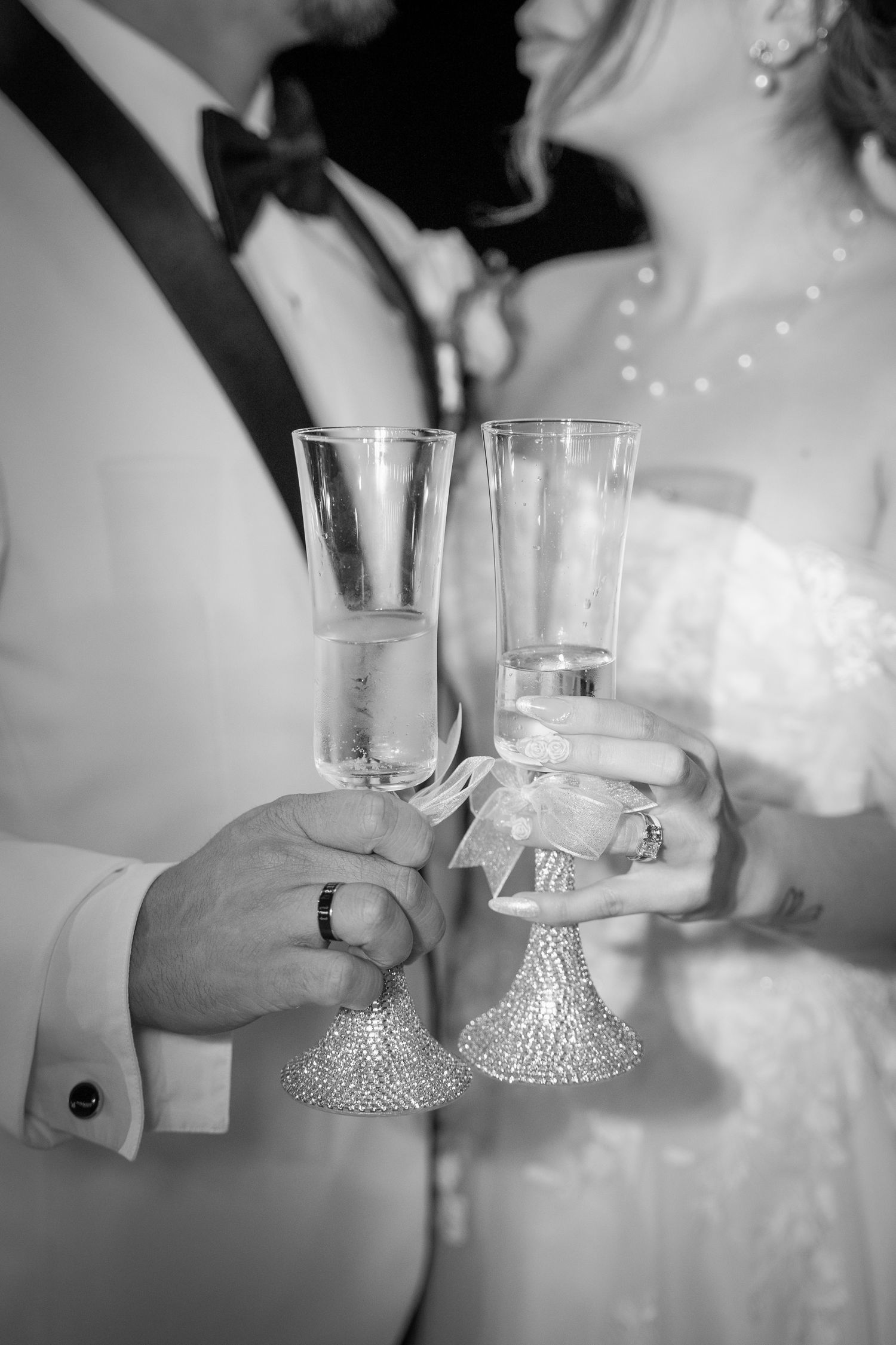 Black and white photo sequence of wedding couple toasting with champagne glasses.