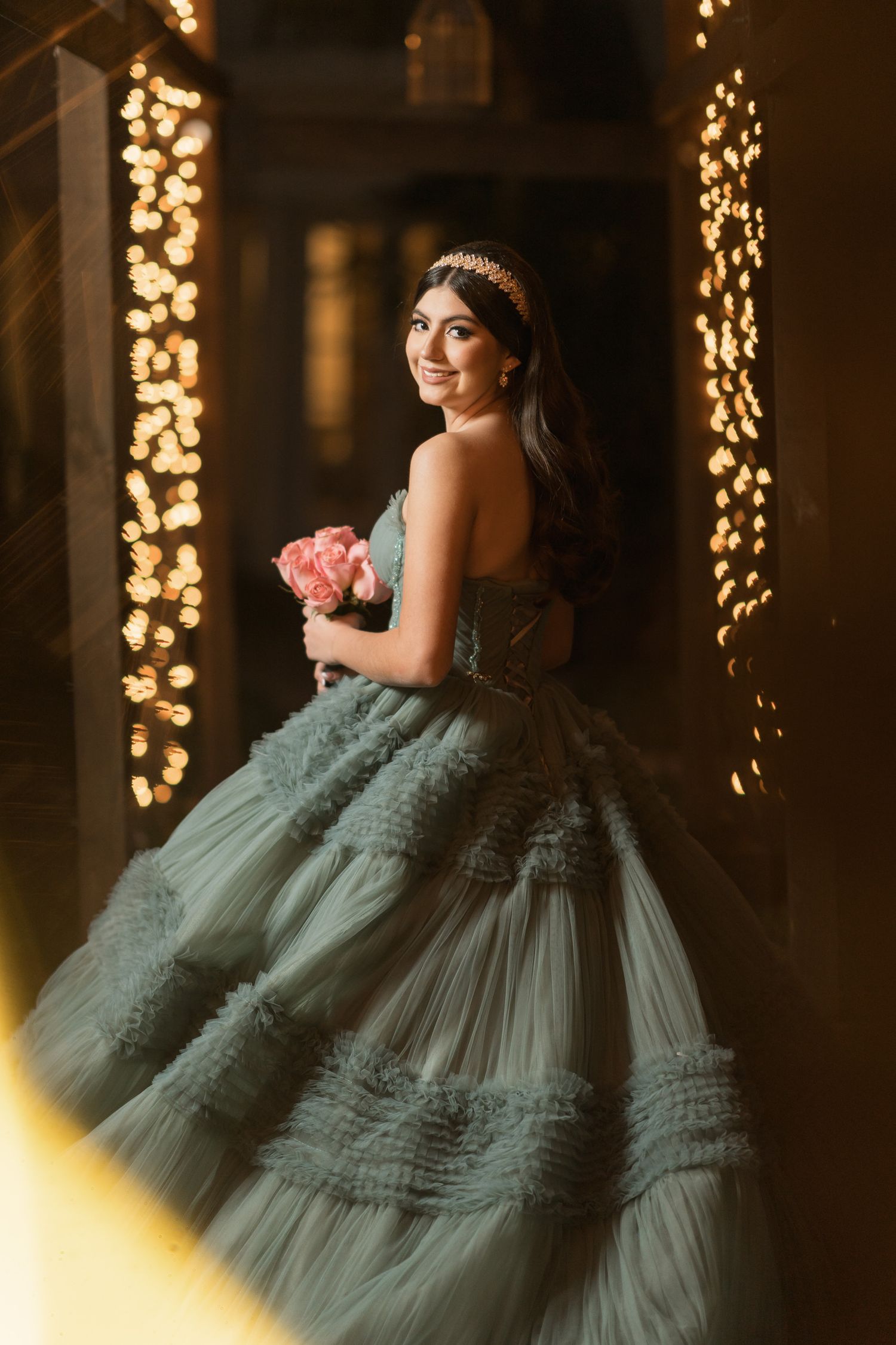 Dramatic evening portraits with warm lighting showcasing detailed blue tulle ballgown.