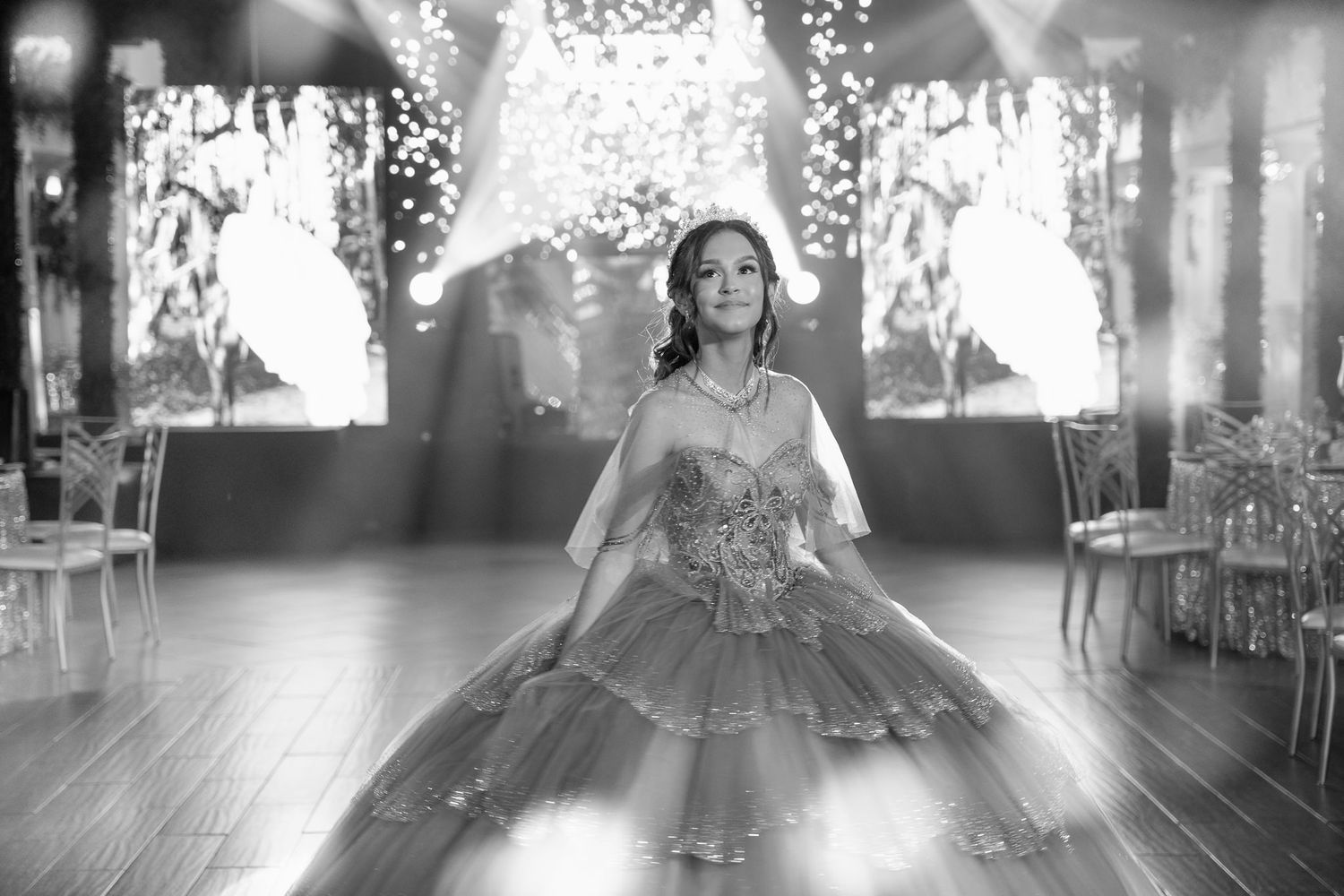 A dramatic black and white photo of a celebration with sparkler effects and elegant decor.
