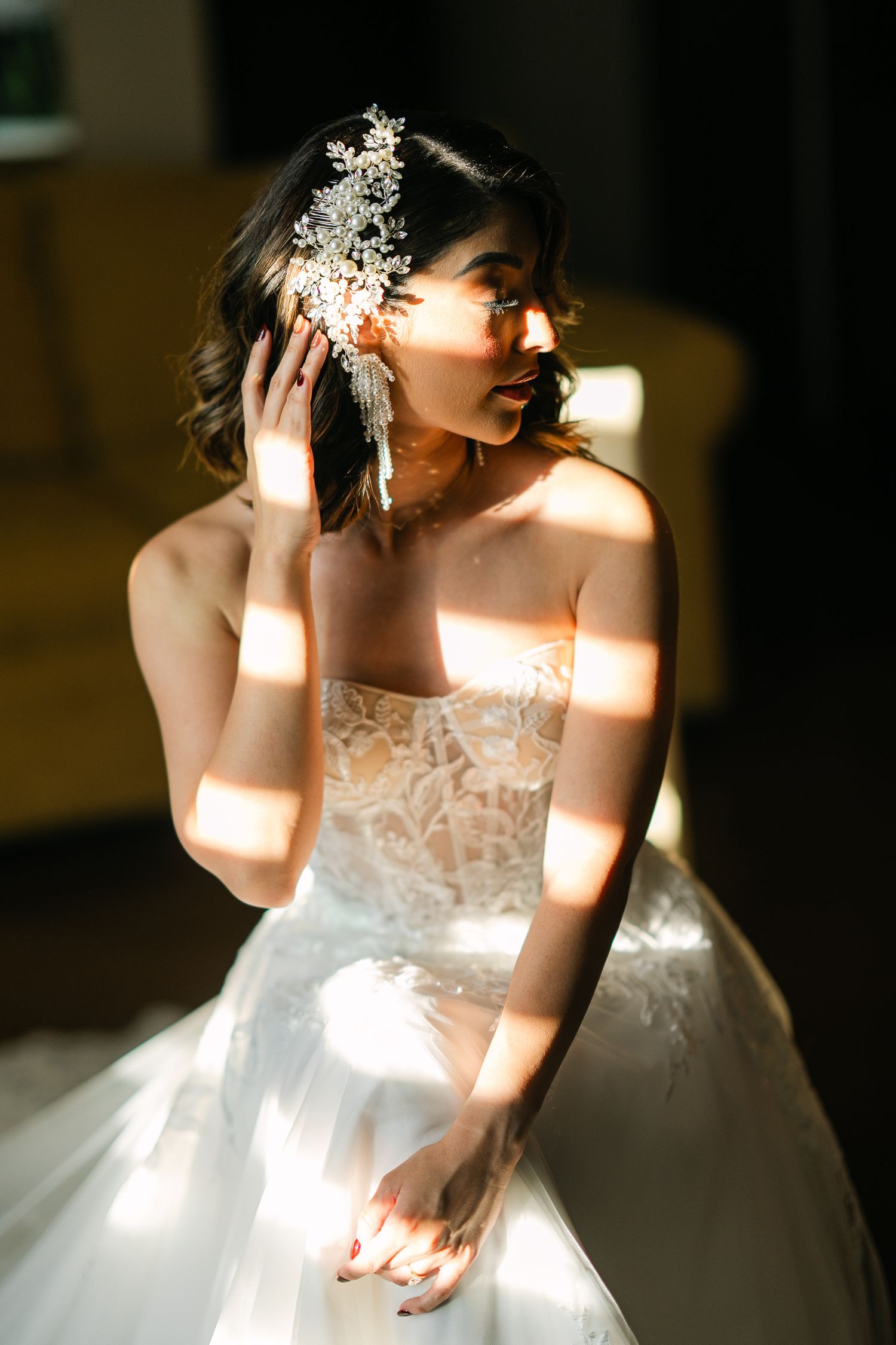 Artistic series of bridal portraits with natural window light creating dramatic shadows.