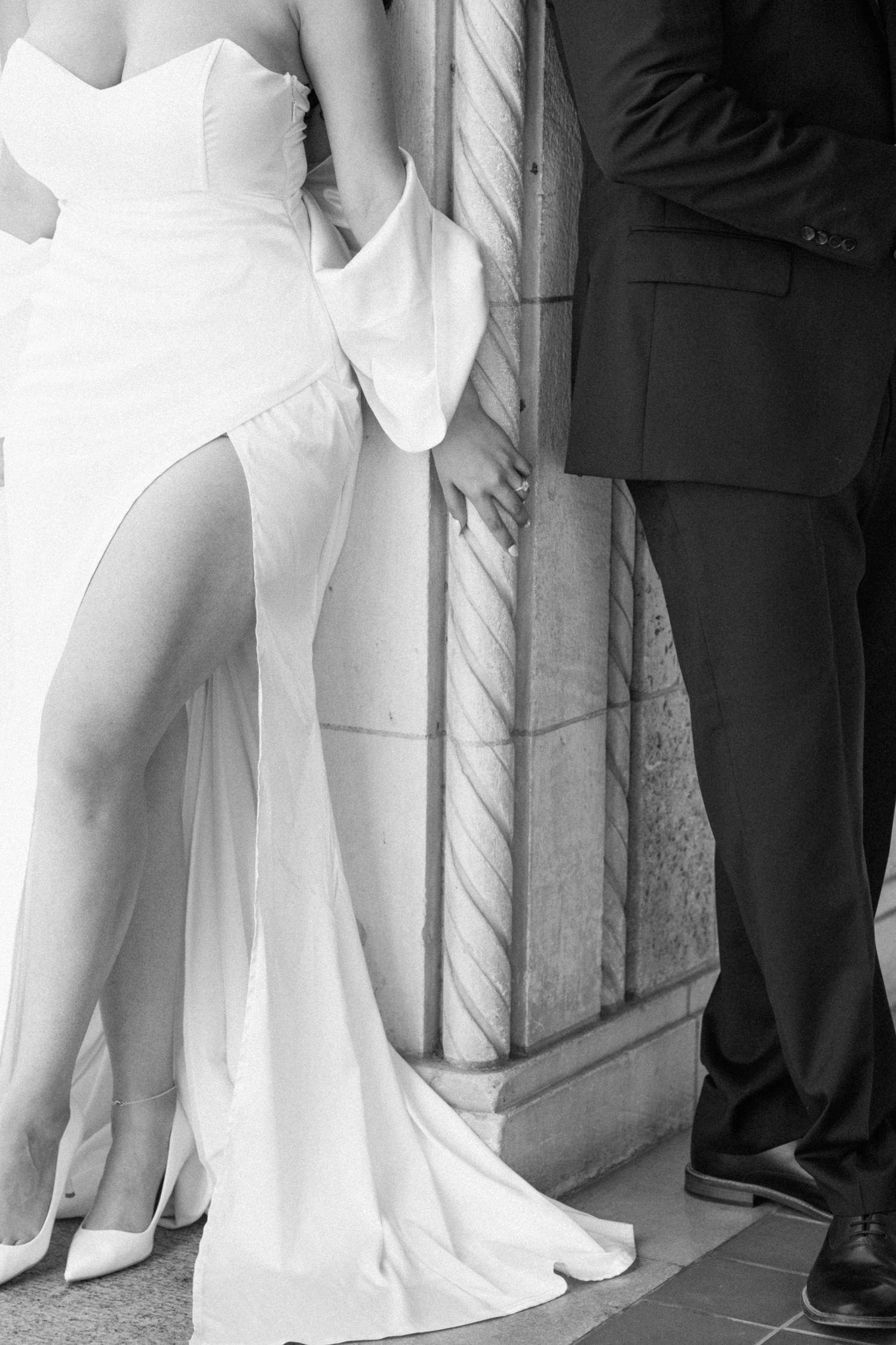 Black and white detail shot of wedding attire and formal wear.