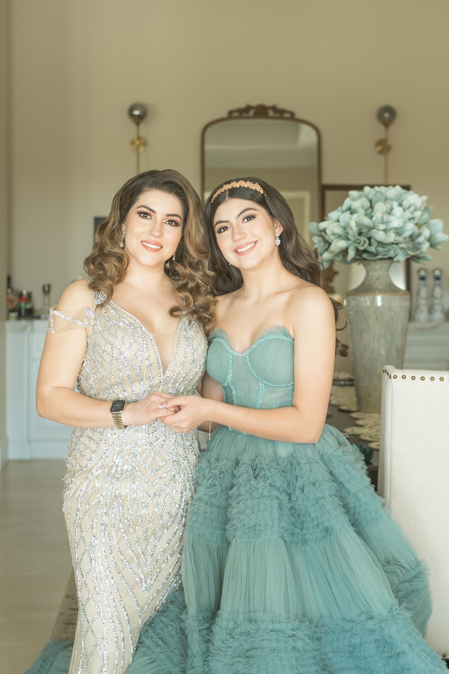 Group photo featuring matching formal dresses in shades of silver and aqua blue.