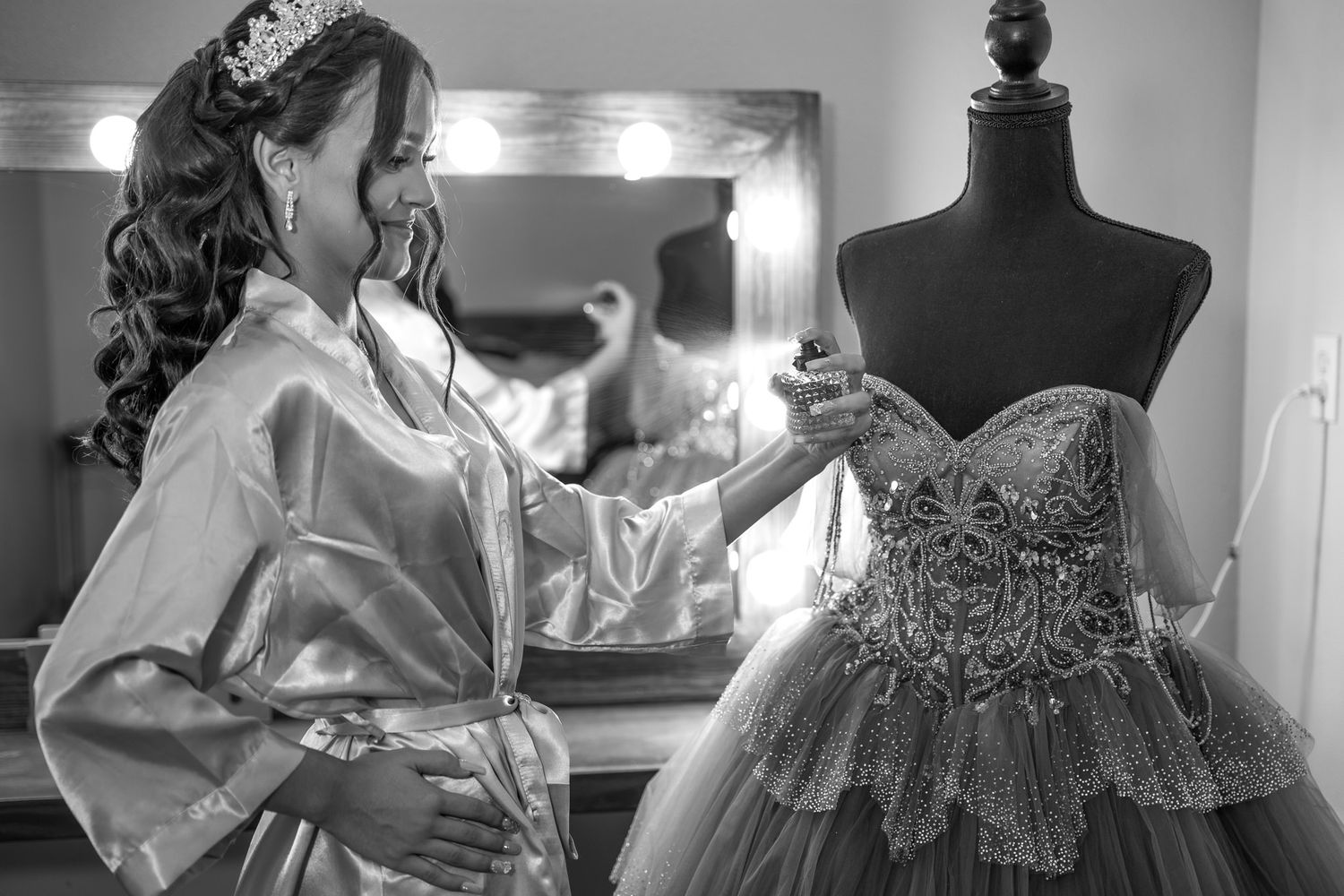 Wedding dress details being prepared in a dressing room with black mannequin forms.