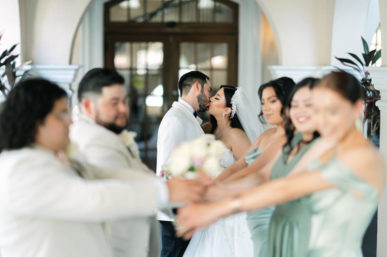 Joyful wedding party celebration with bridesmaids in soft pastel dresses.
