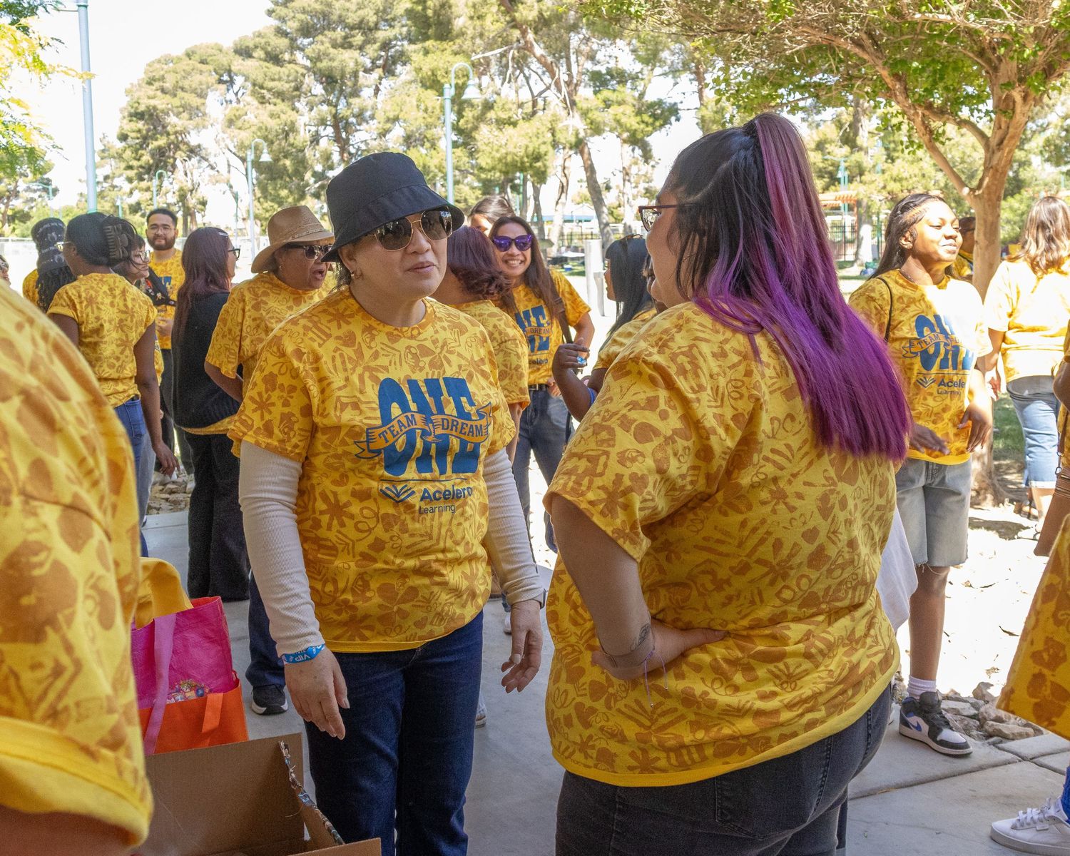 Participants in bright yellow shirts enjoying outdoor community activities.