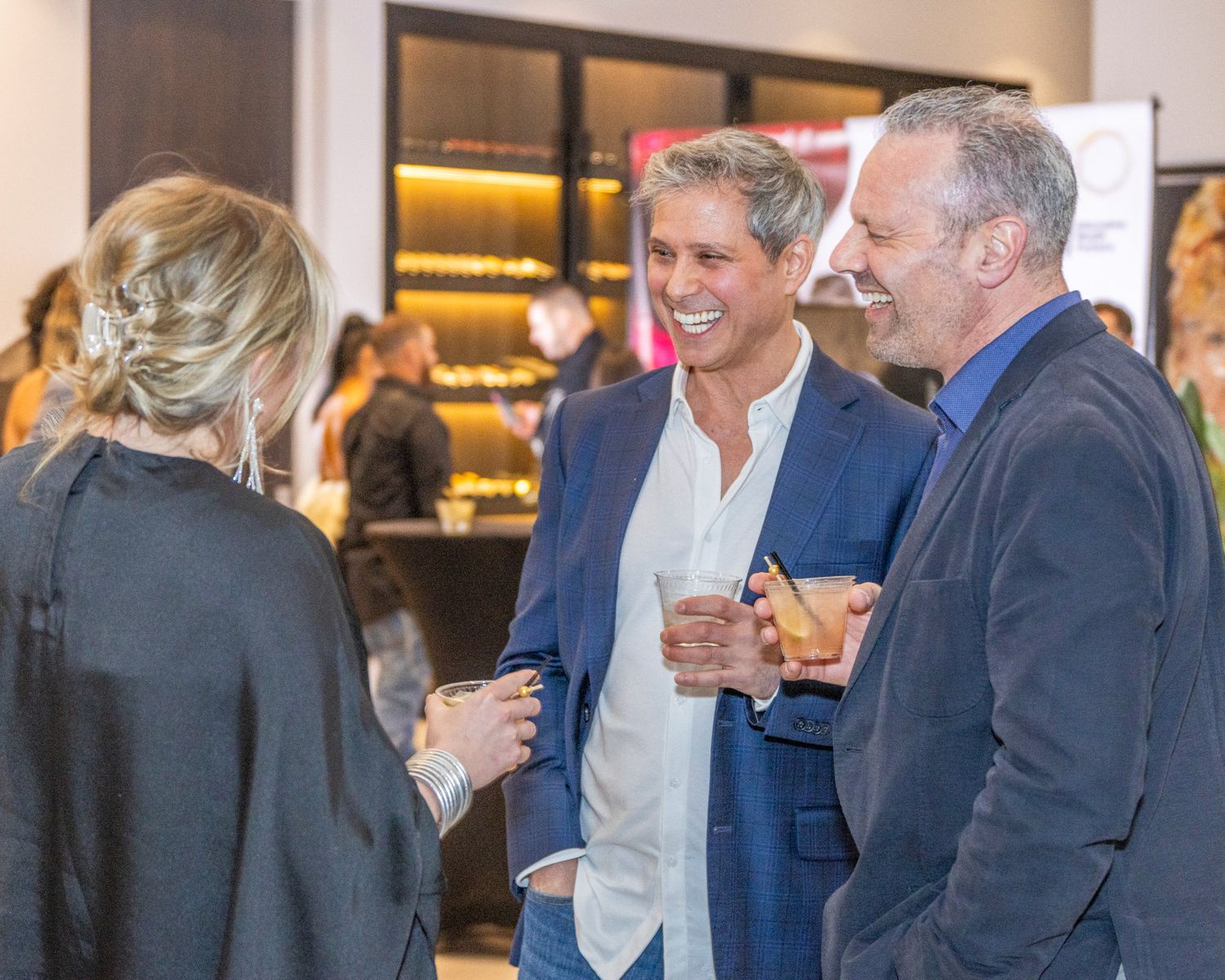 Networking event scene with attendees engaged in conversation.