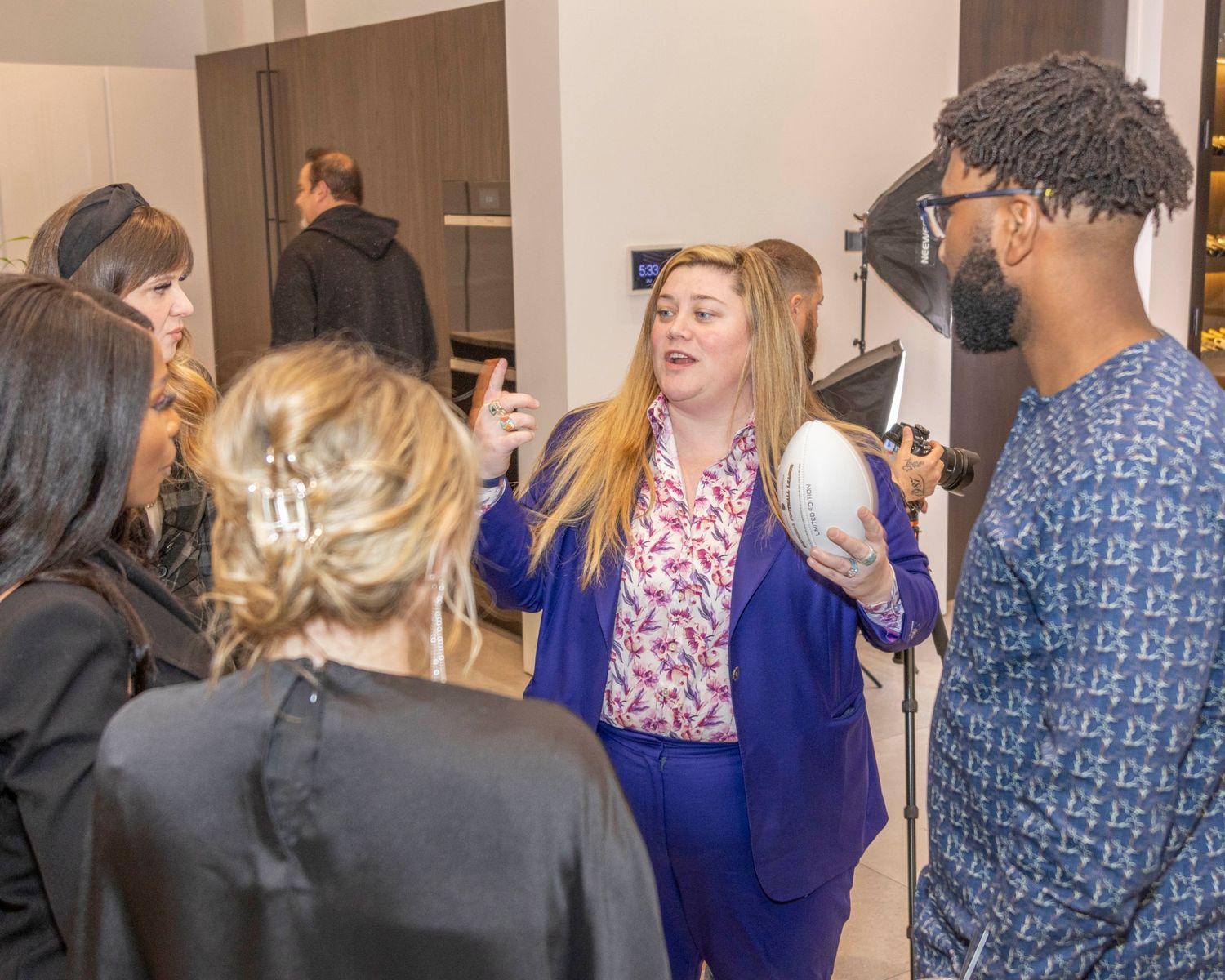 Indoor social gathering with guests in business casual attire.